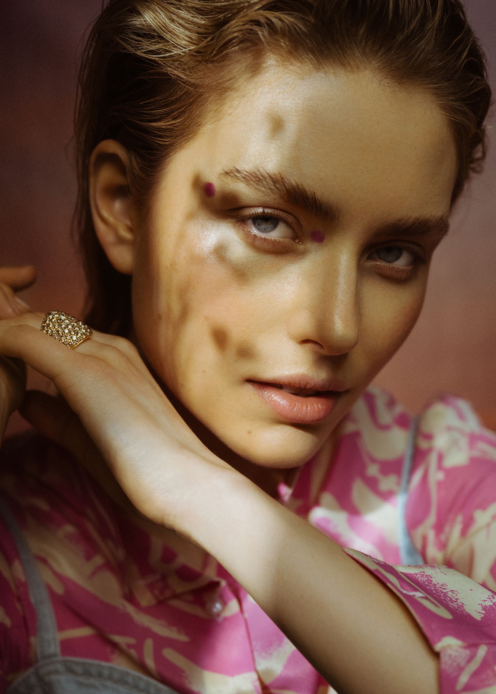 a woman is posing with her hand on her face