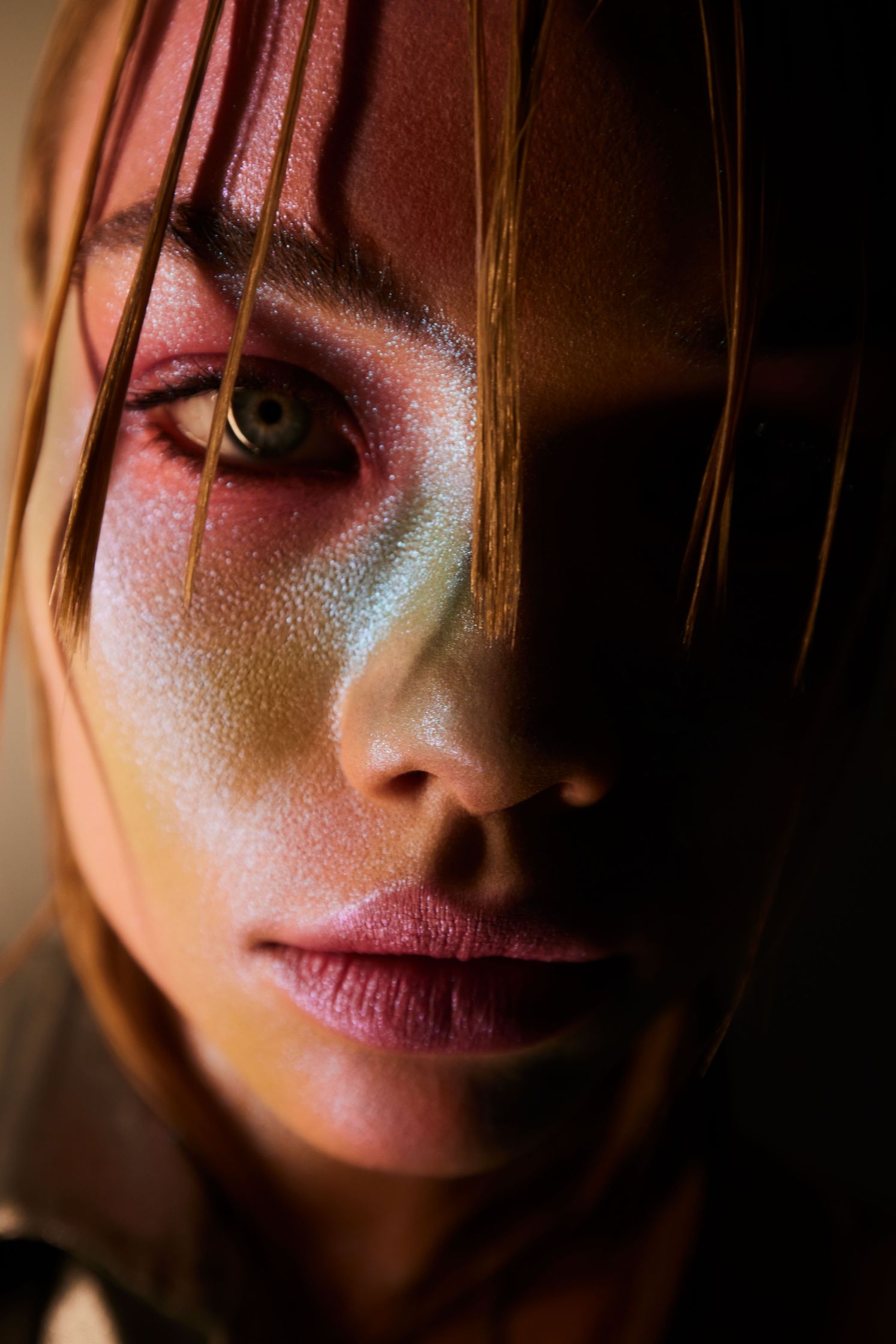a woman with colorful makeup on her face