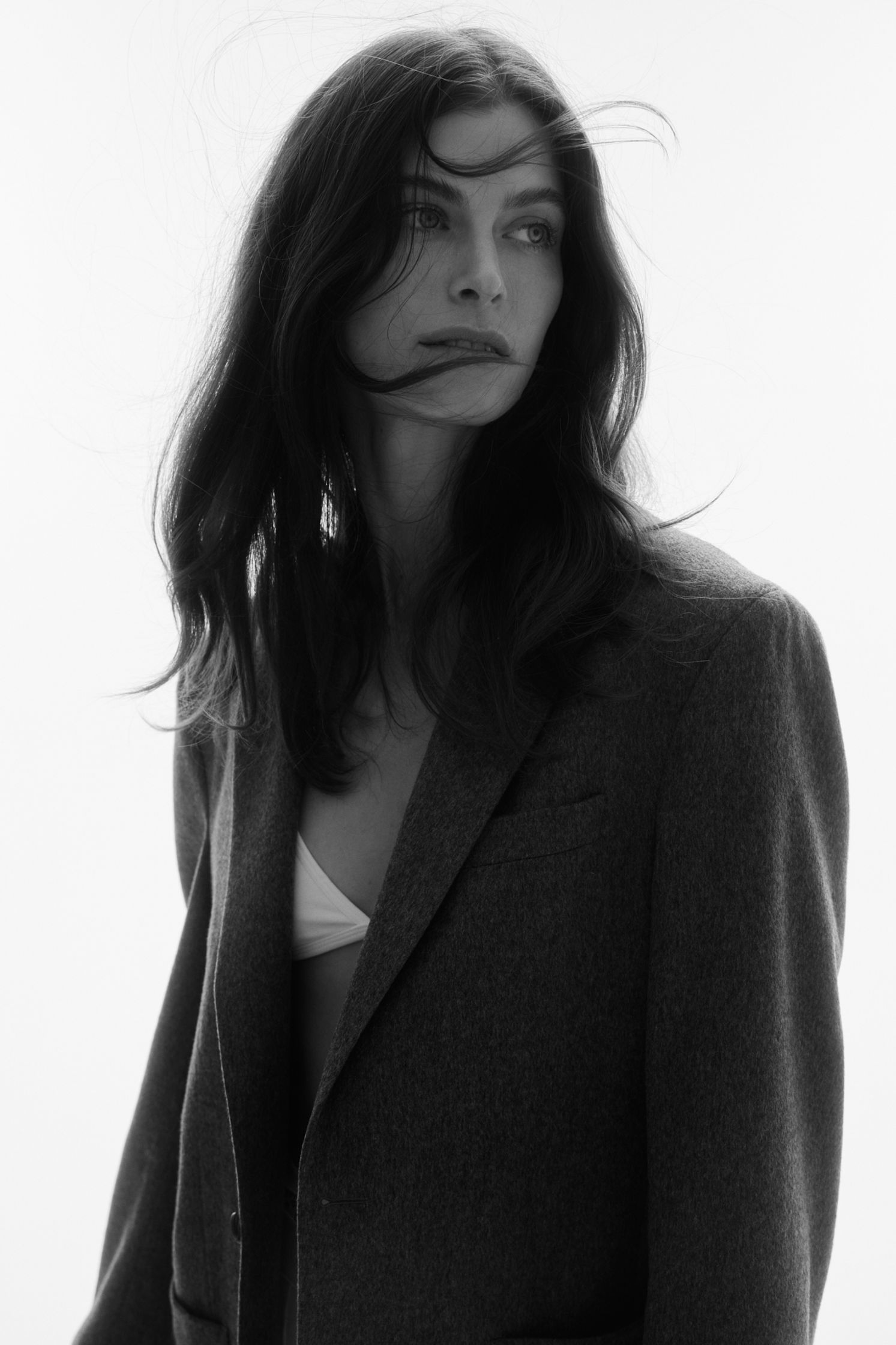 a black and white photo of a woman in a suit