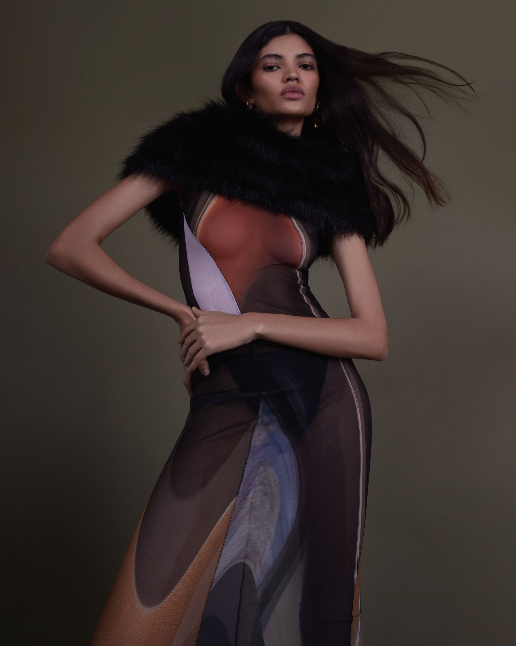 a model in a long dress with fur
