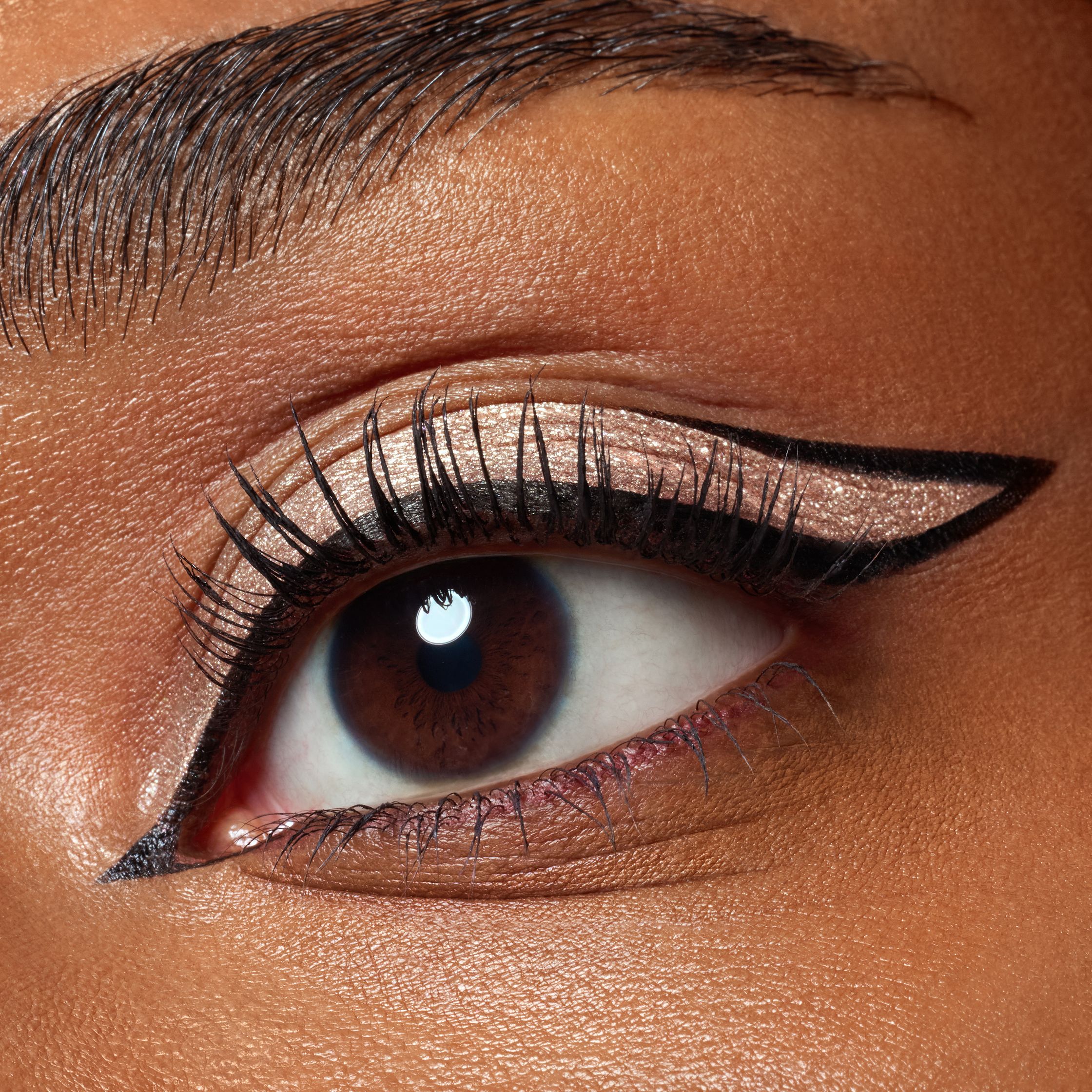 a close up of a woman's eye with black eyeliner