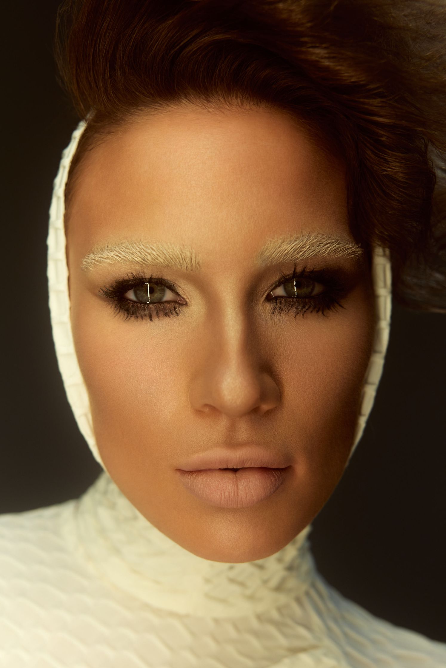 a woman in a white outfit with makeup on her face