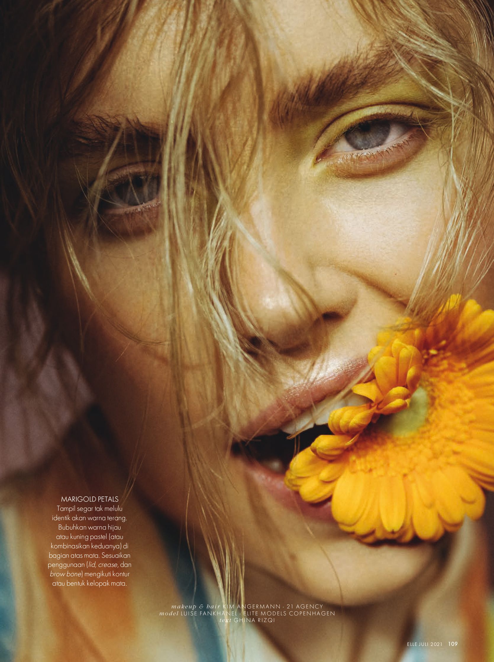 a woman with a flower in her mouth