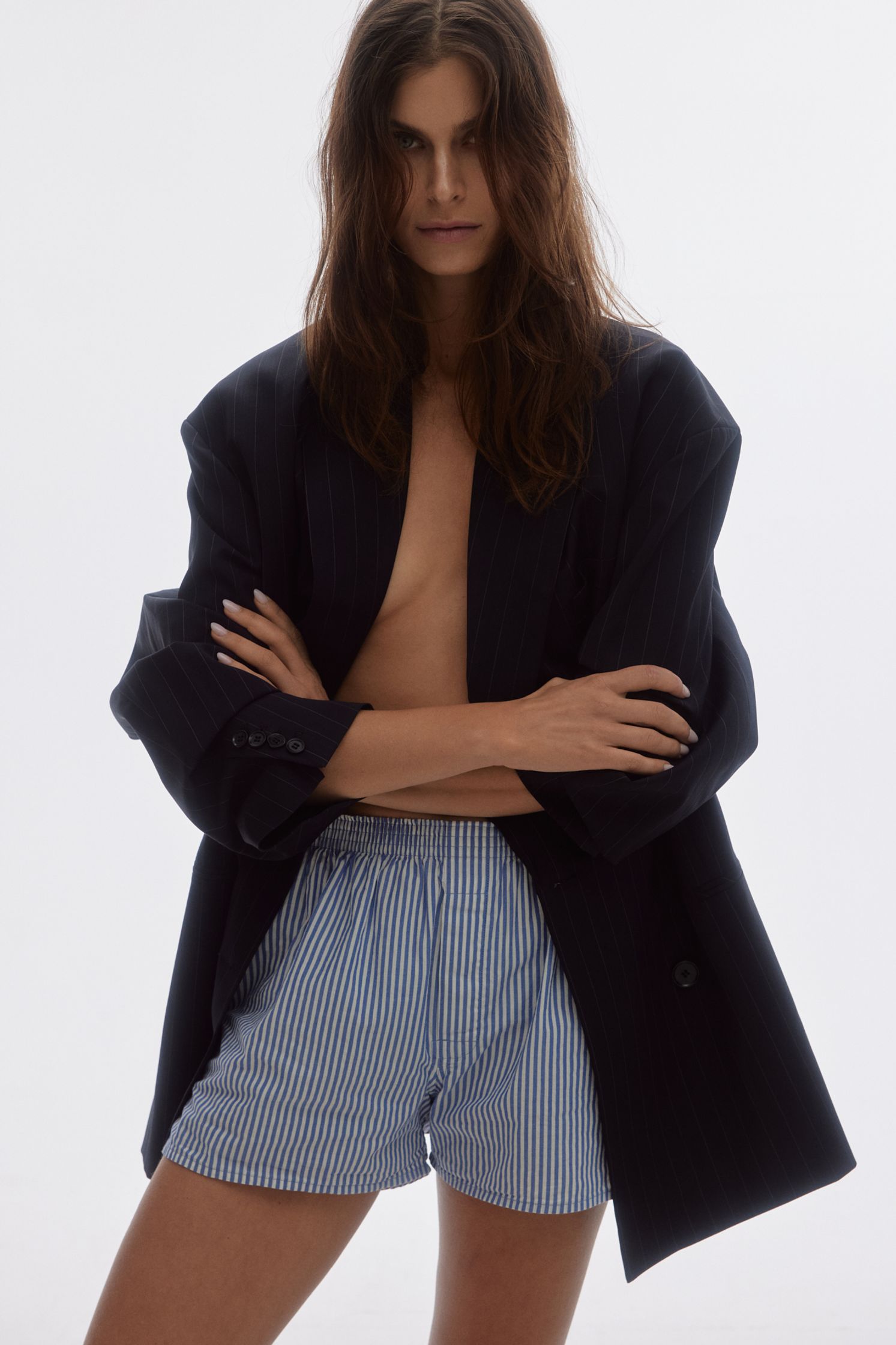 a model in blue and white striped shorts posing for a photo shoot