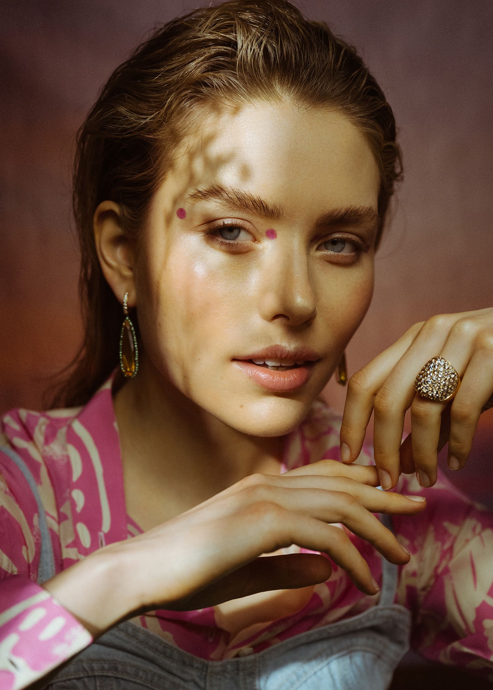 a woman is posing with a ring on her finger