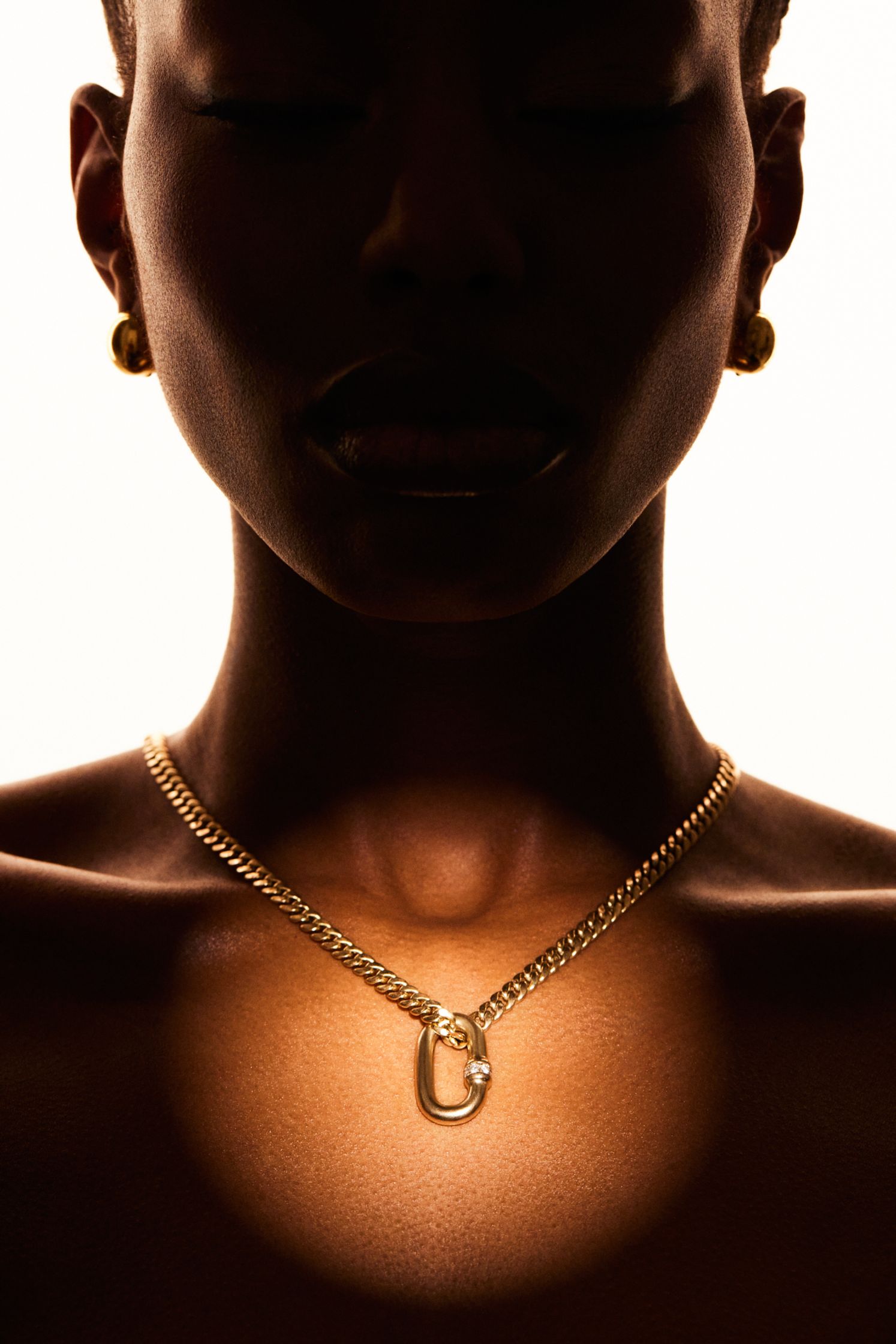 an image of a woman wearing a gold necklace