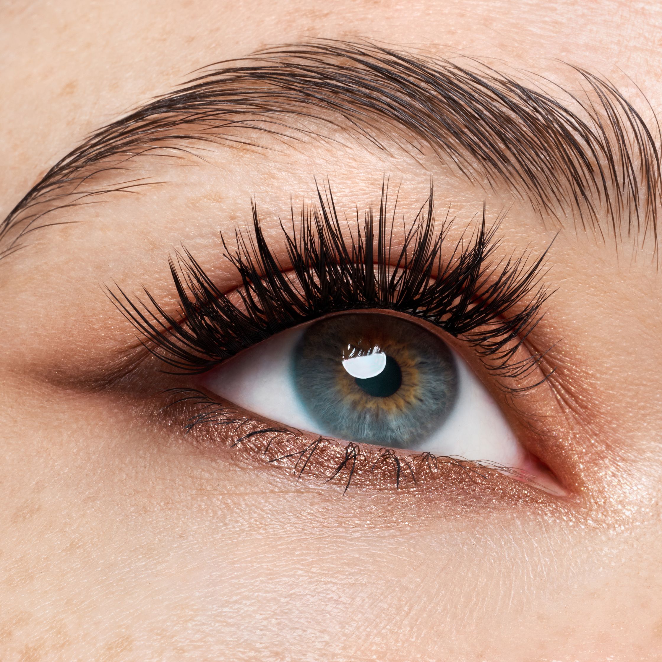 a close up of a woman's eye with long lashes