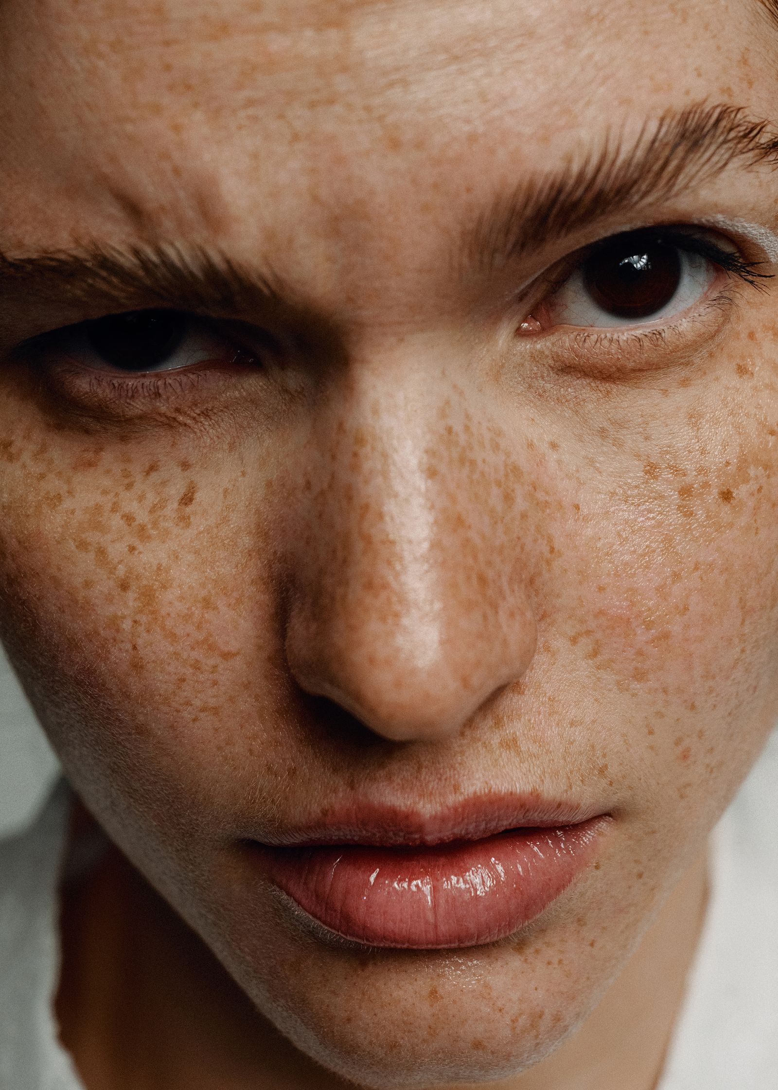 a close up of a woman with freckles on her face