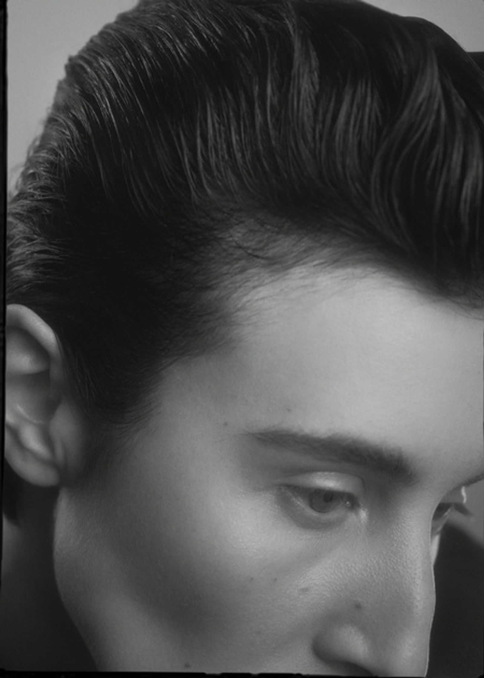 a black and white photo of a young man