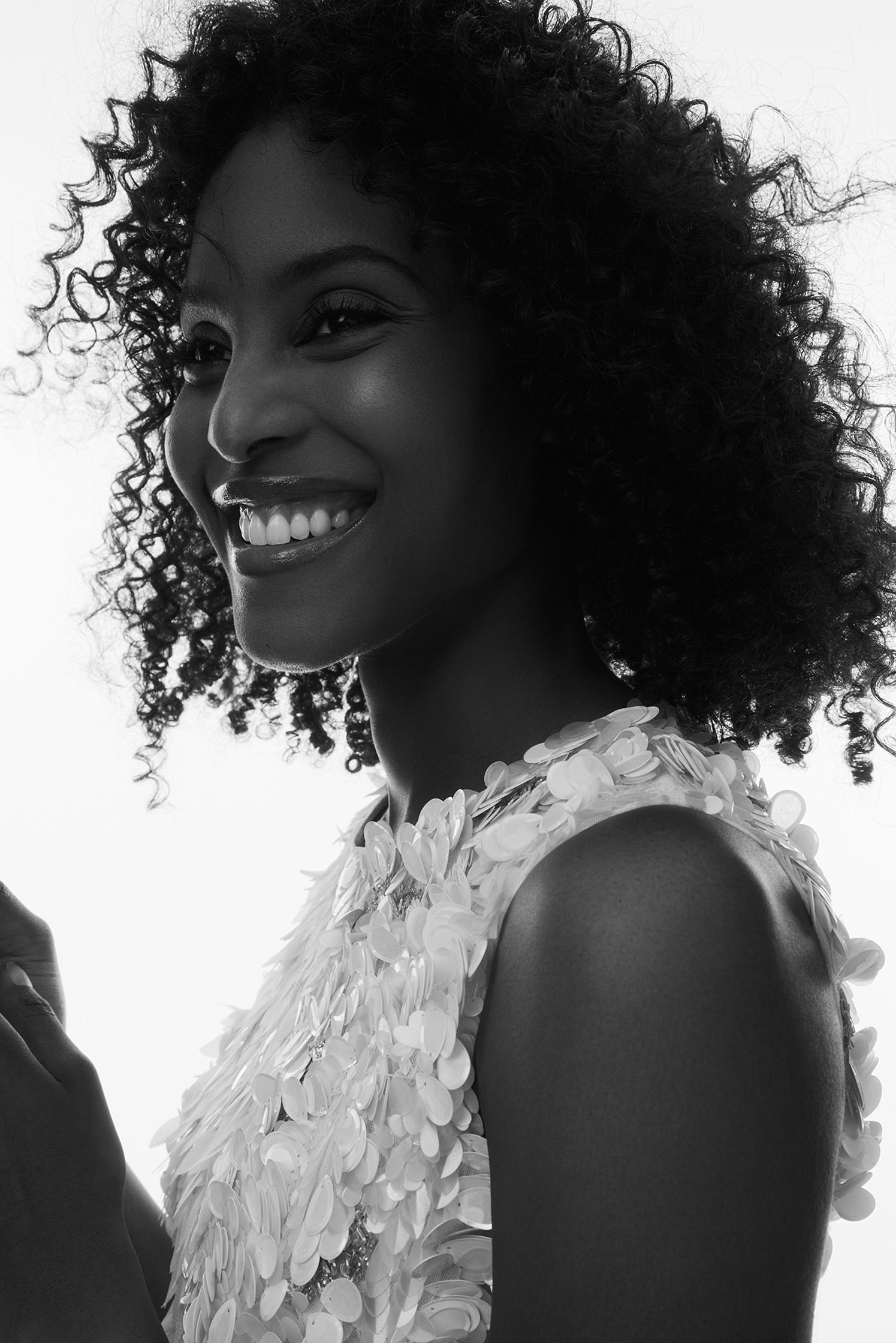 a black and white photo of a woman smiling