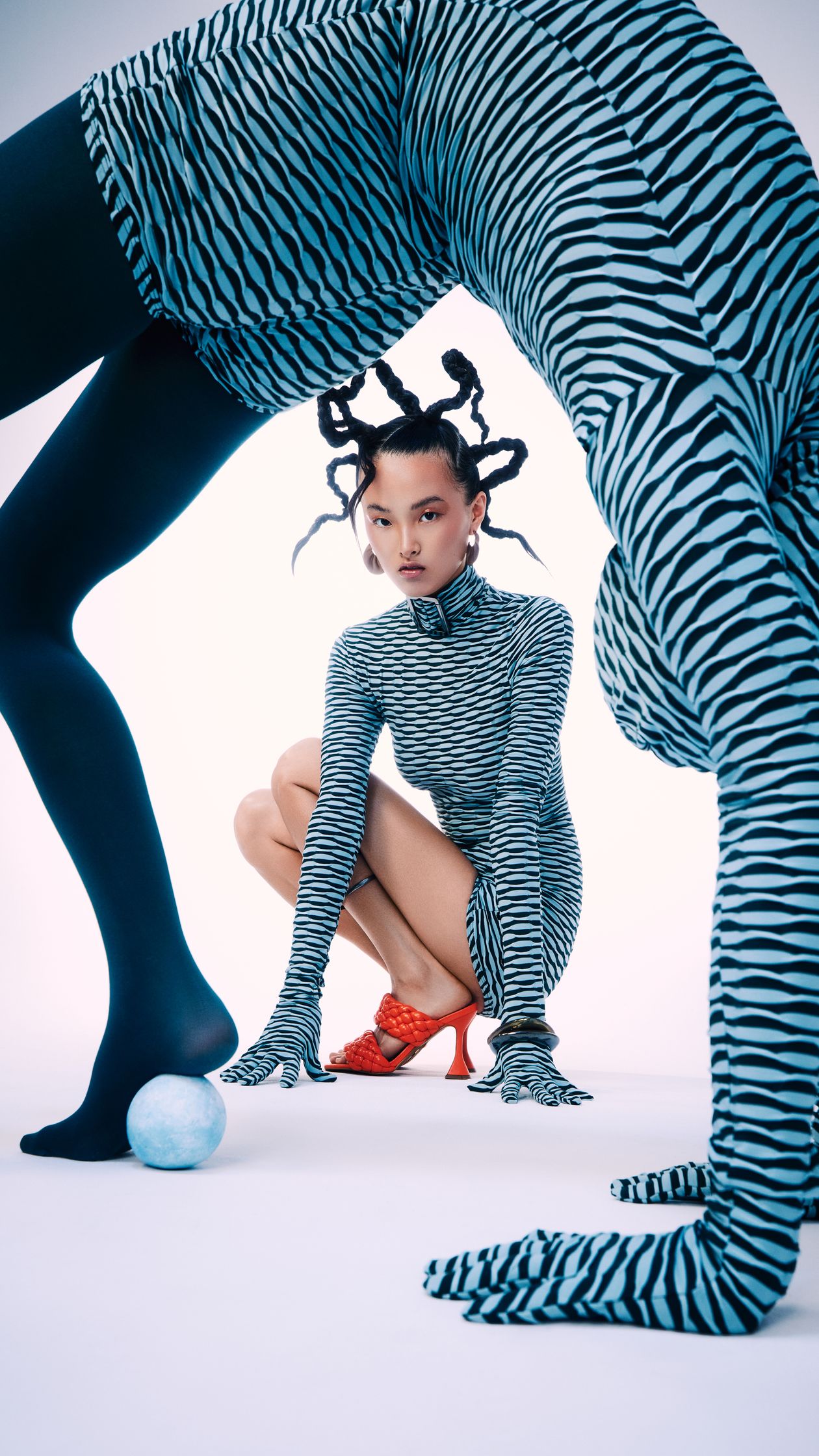a woman in a zebra print outfit posing with a ball