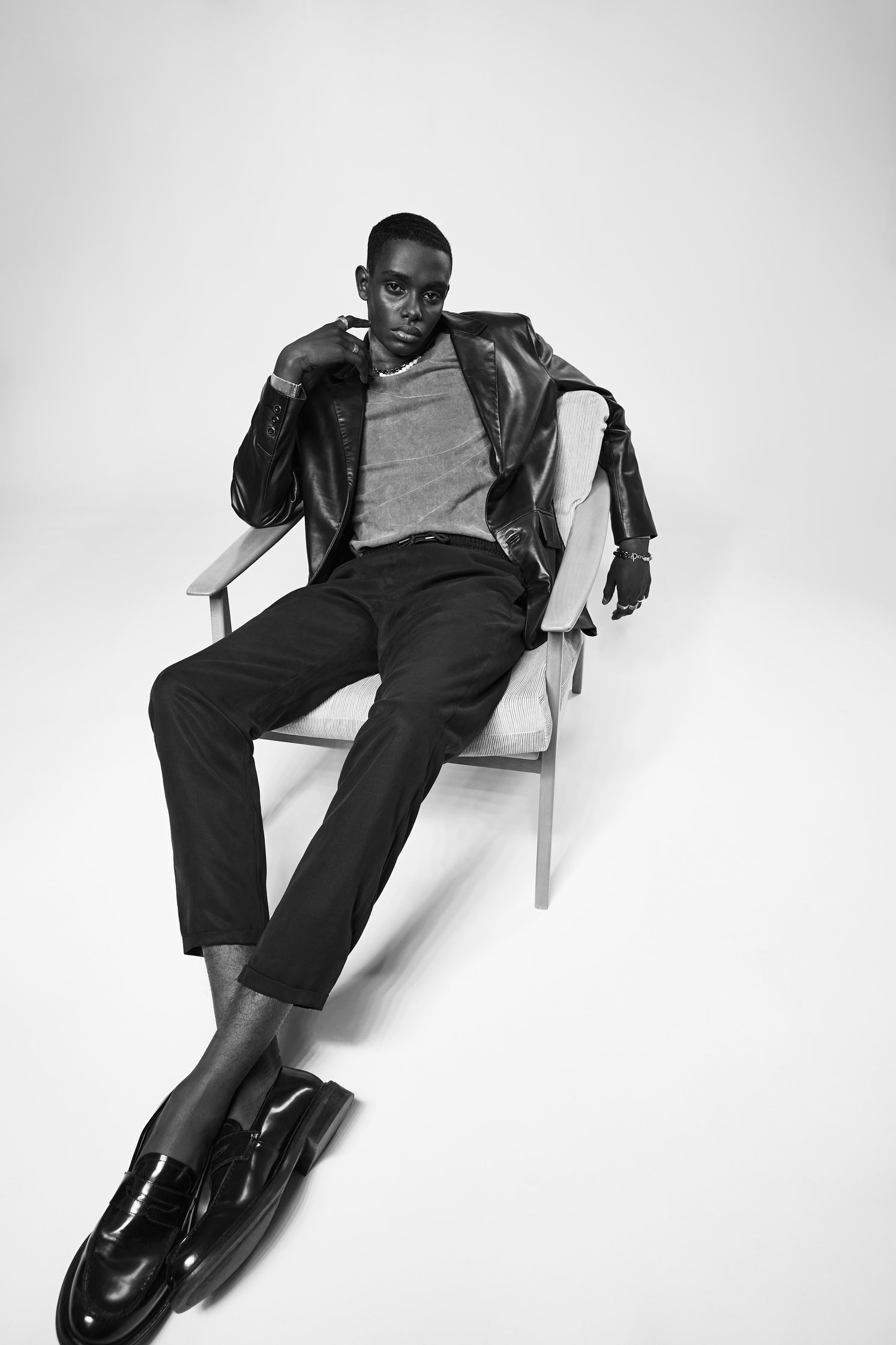 a black and white photo of a man sitting in a chair