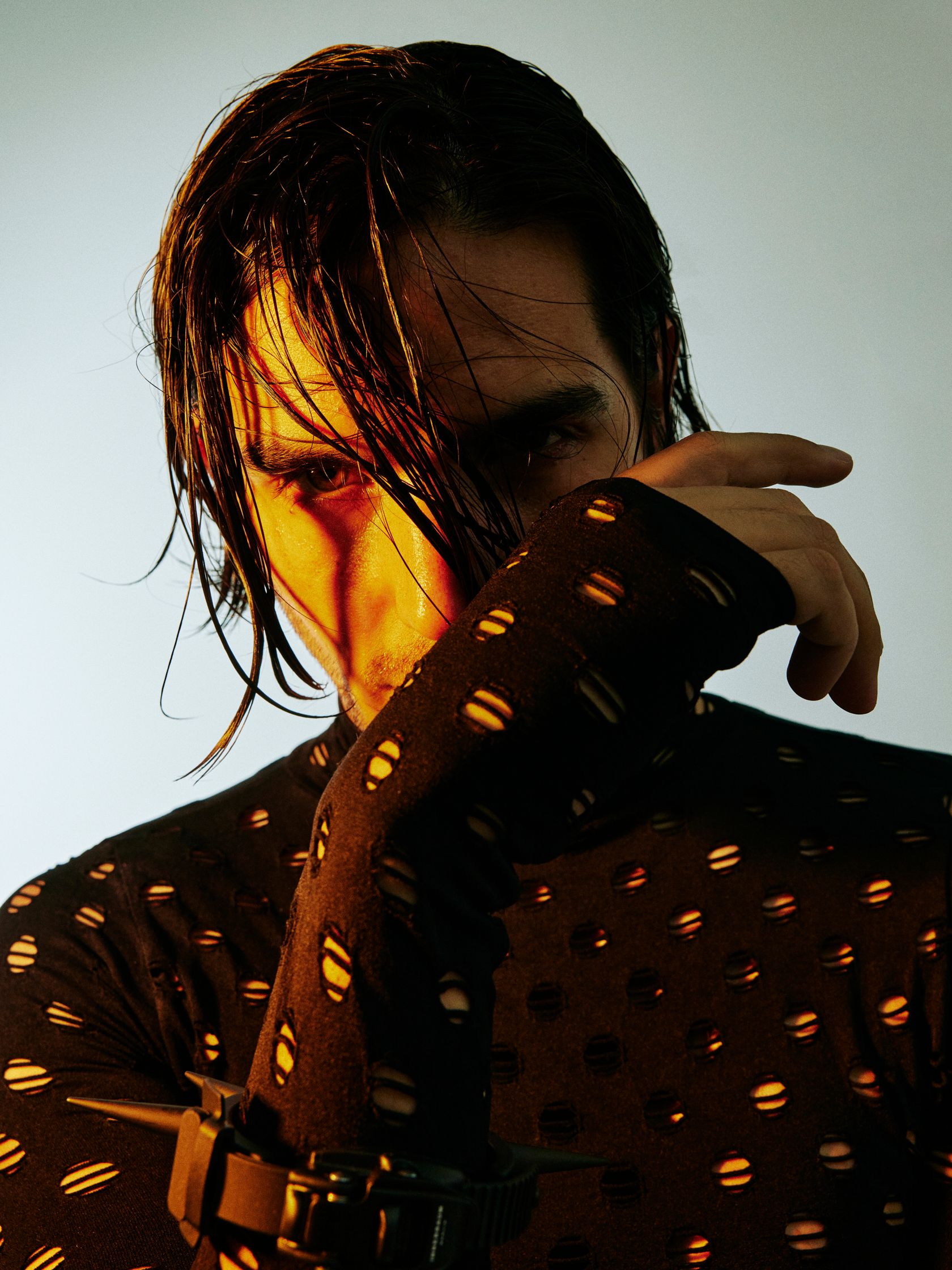 a man wearing a polka dot shirt and cuffs