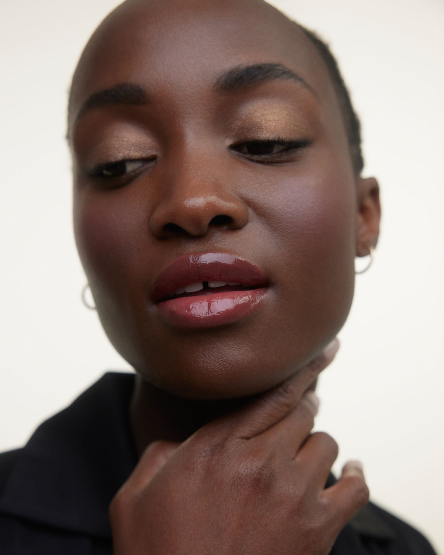 a black woman posing with her hand on her chin