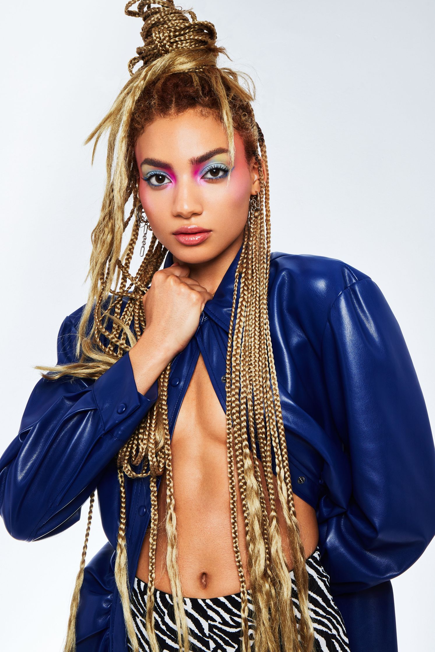a woman in a blue jacket and zebra print top