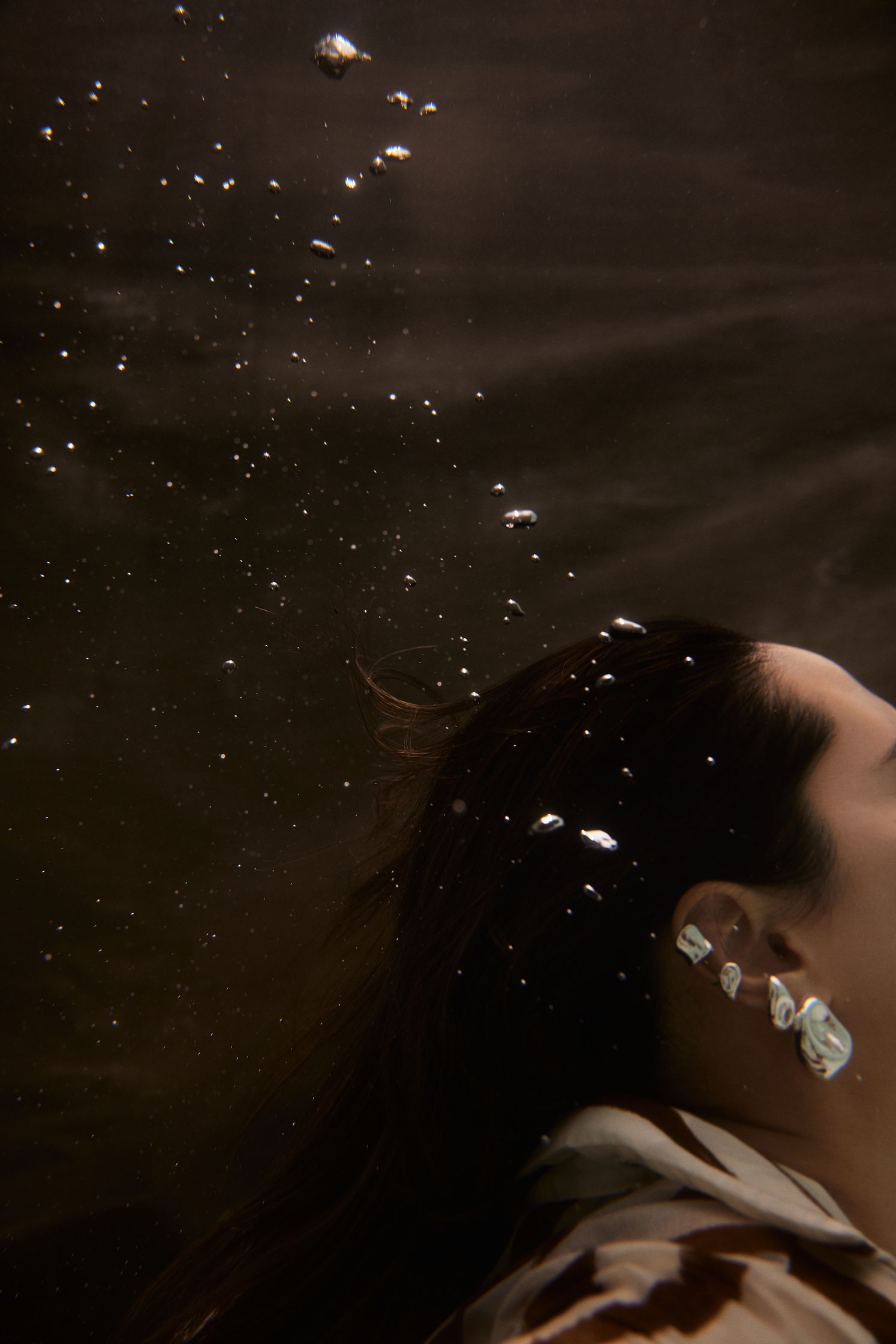 a woman with ear piercings in the water
