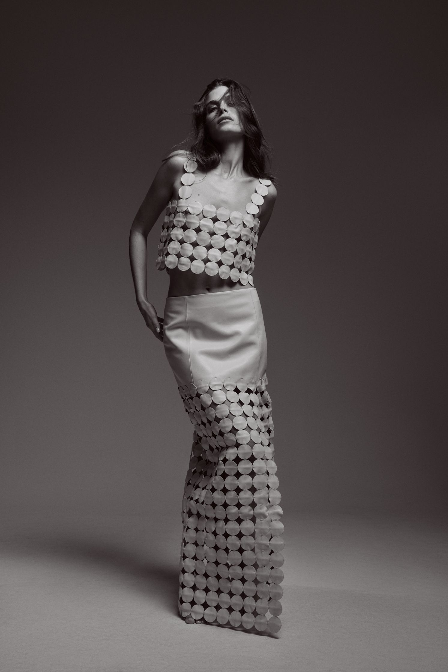 a woman in a long dress posing for a photo shoot