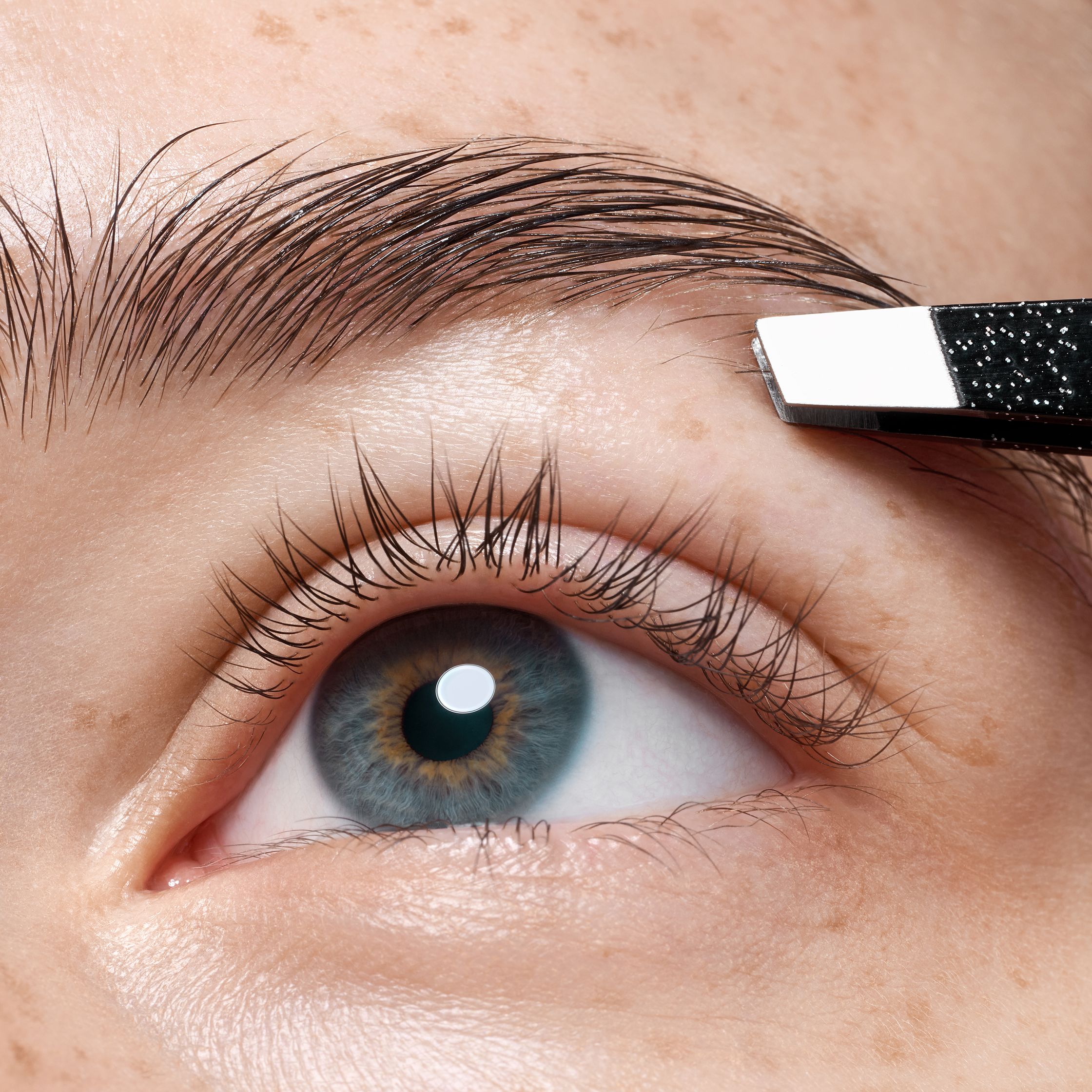 a close up of a woman's eyebrows with a brow pencil