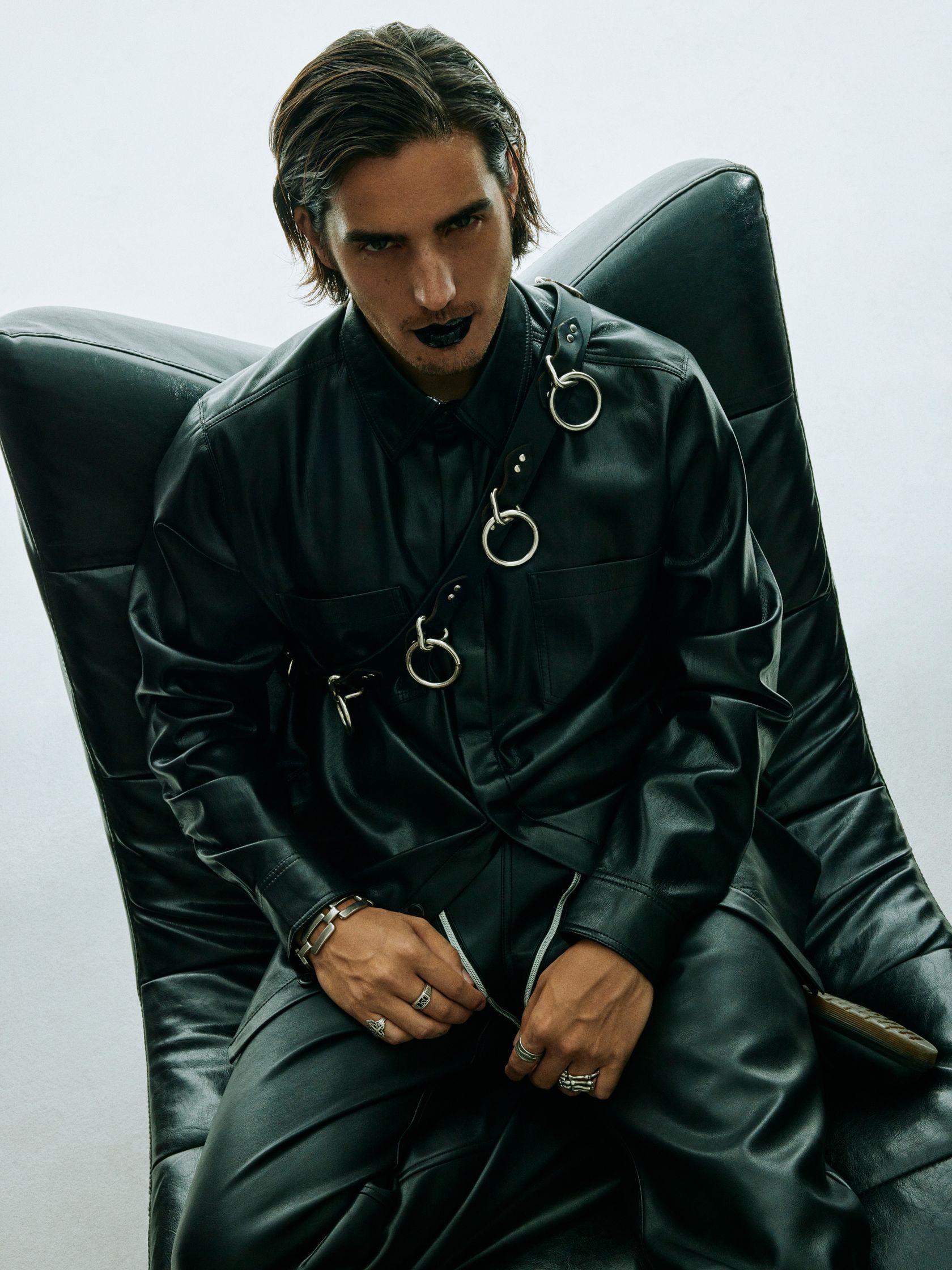a man sitting in a black leather chair