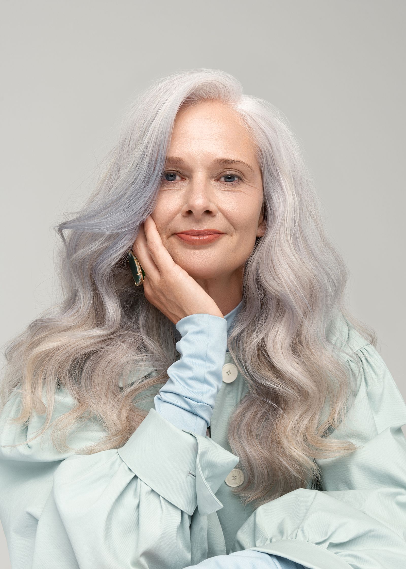 a woman with gray hair posing for a photo