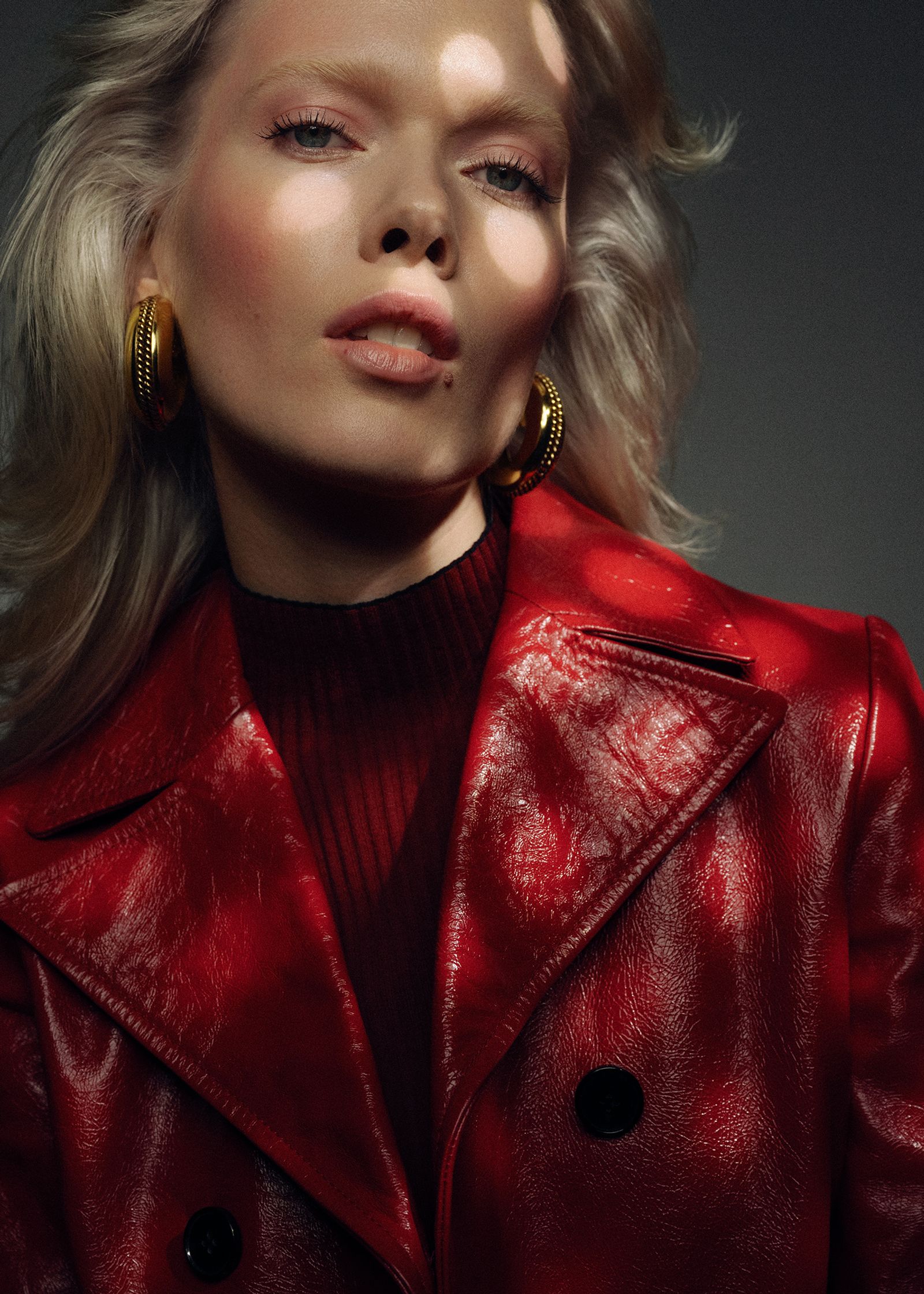 a woman in a red leather jacket posing for a magazine