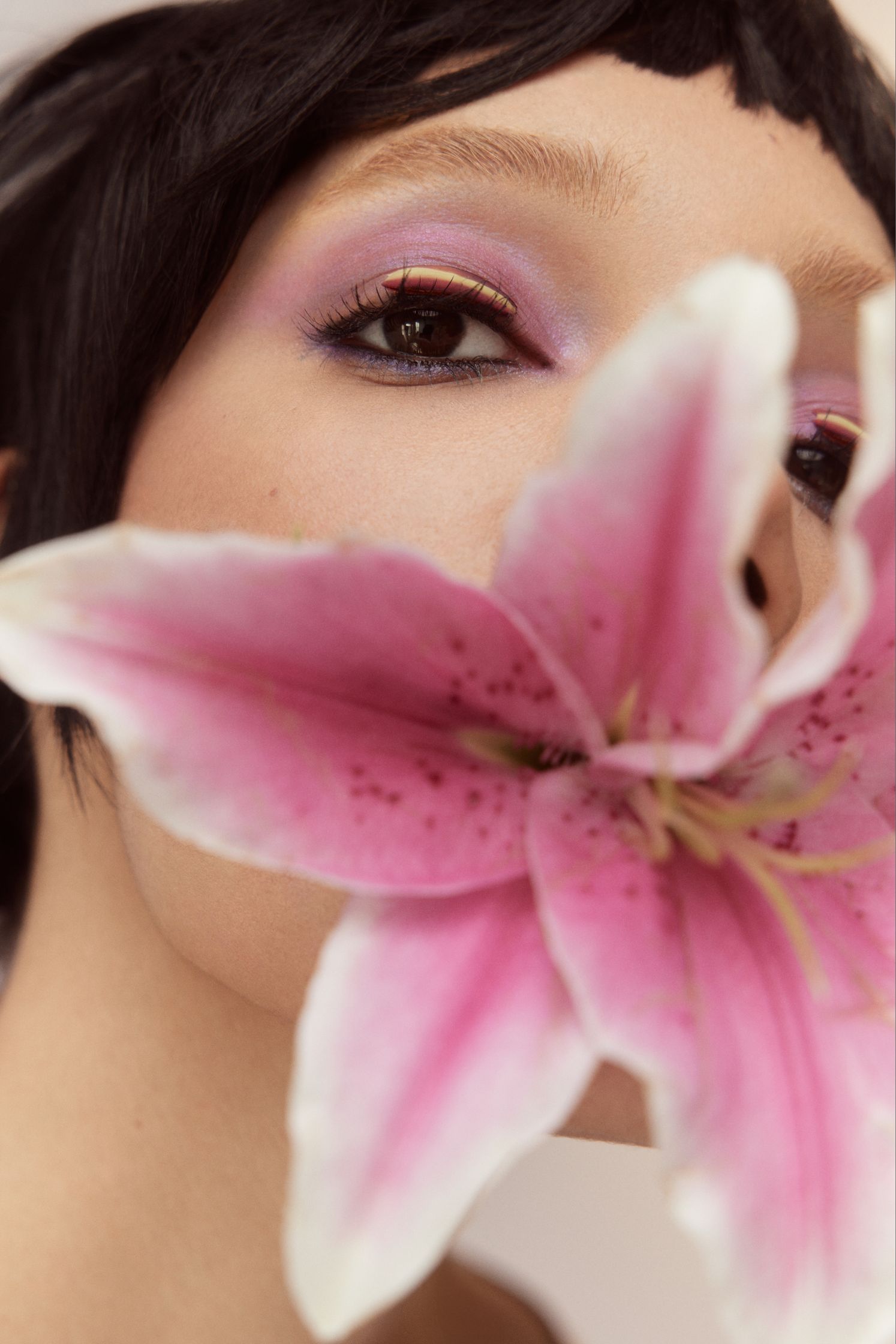 a woman is holding a flower in her mouth