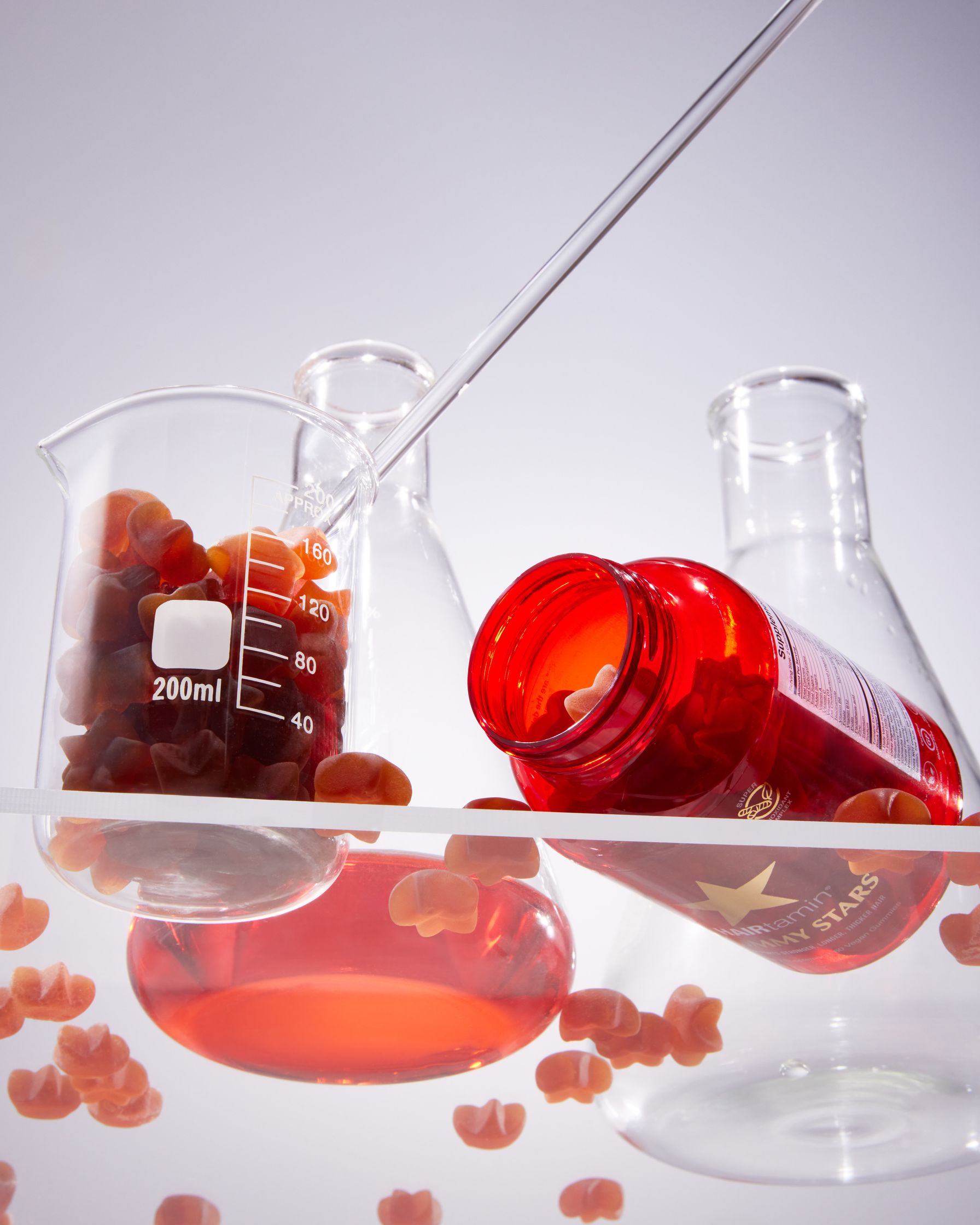 a glass beaker filled with red liquid
