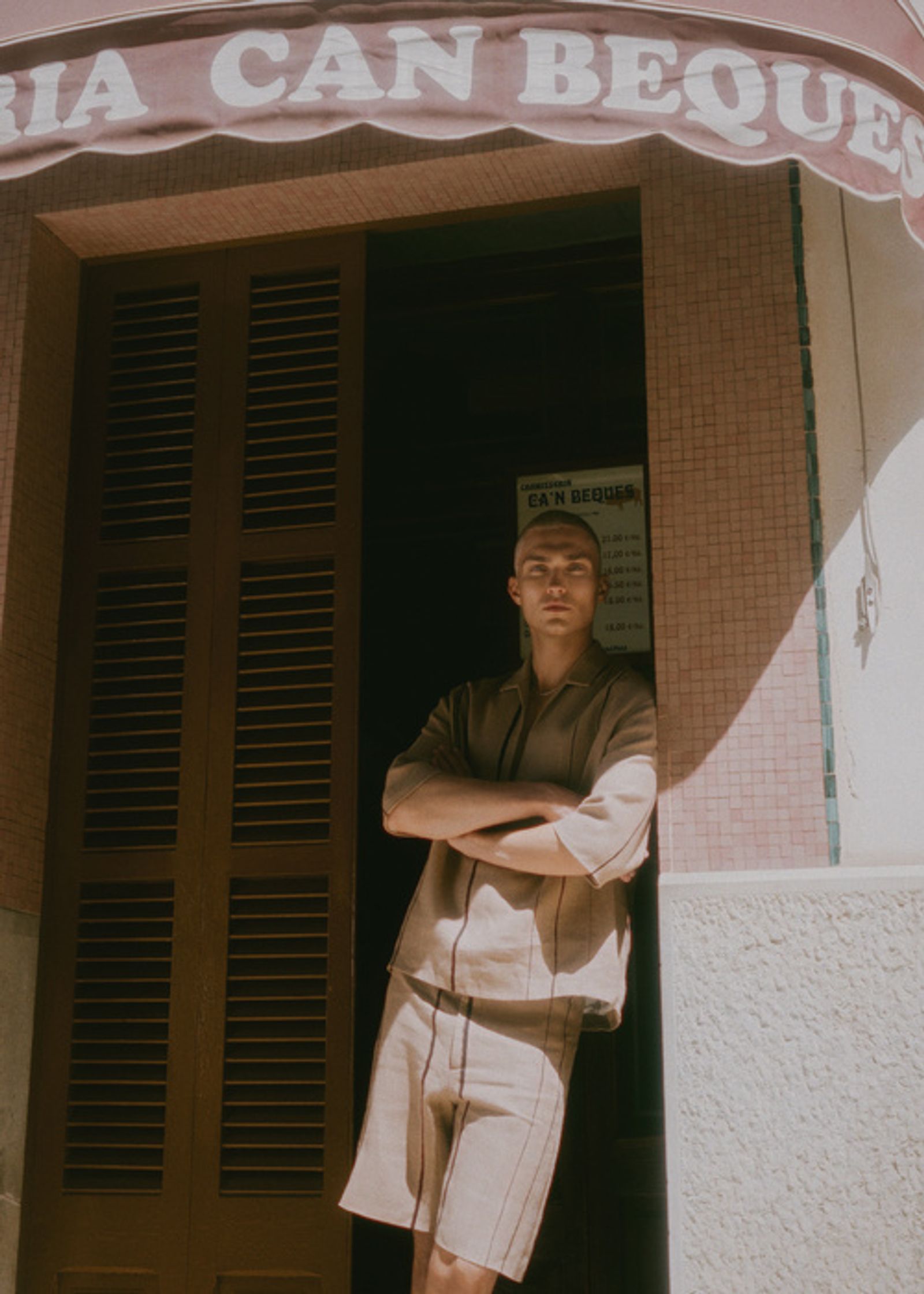 a man standing in front of a restaurant