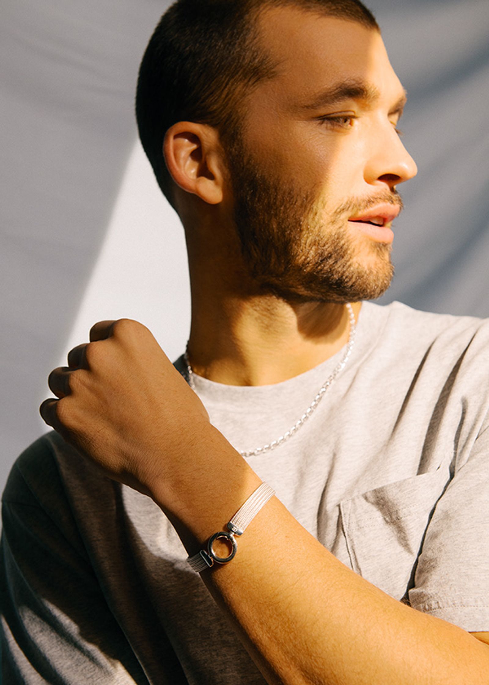 a man with a beard wearing a grey t - shirt