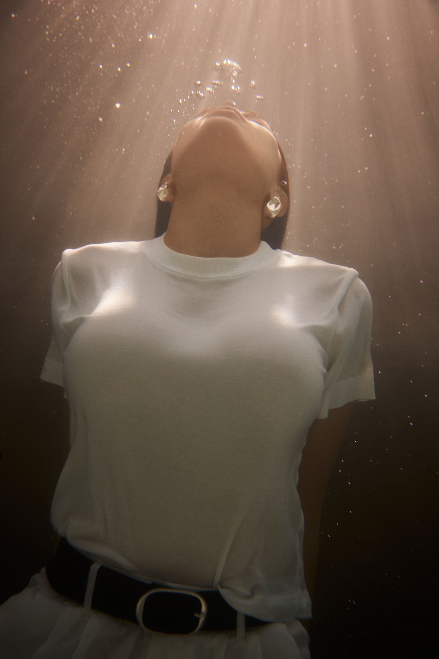 a woman in a white shirt under water