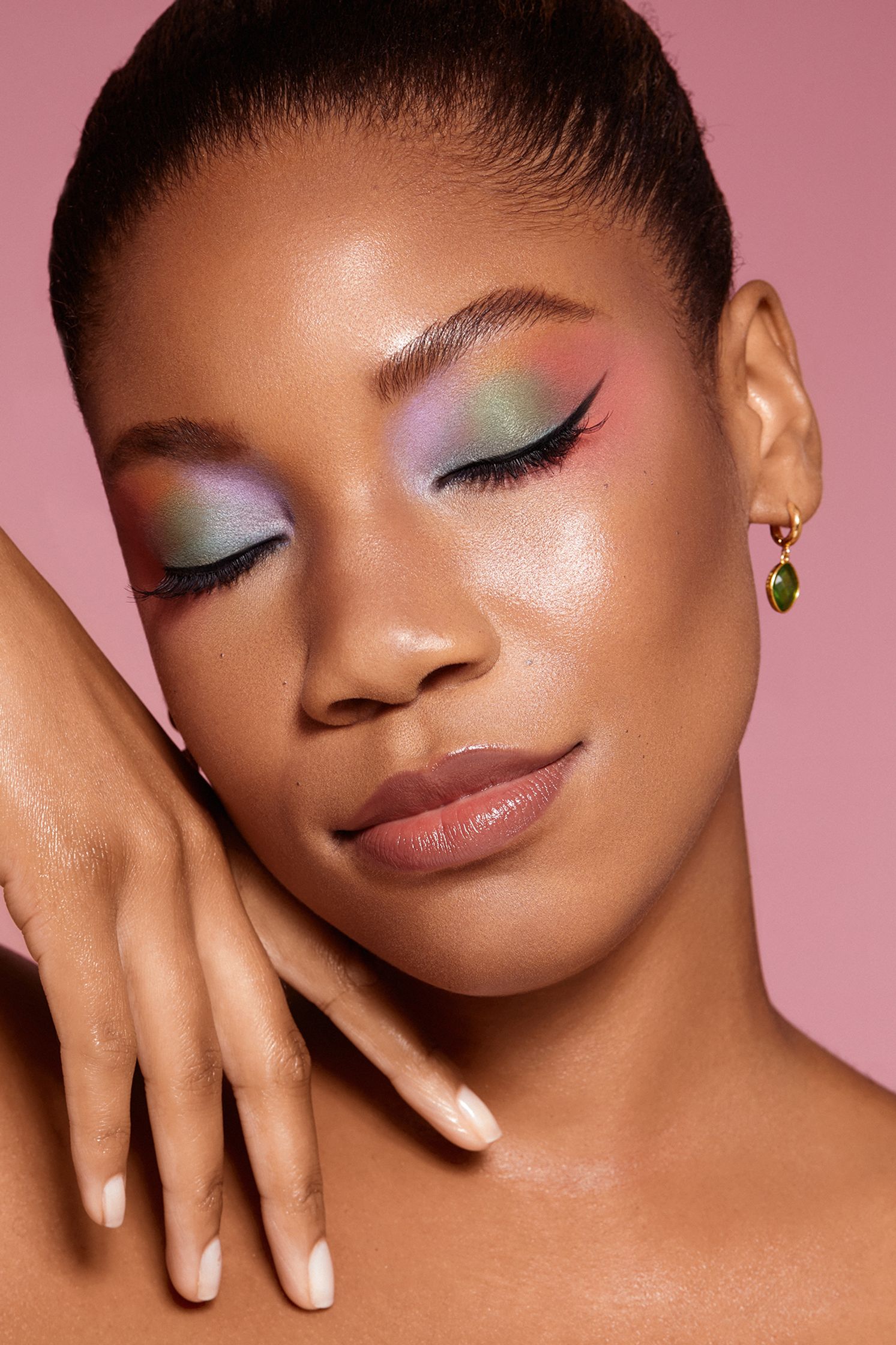 a black woman with colorful makeup on her face