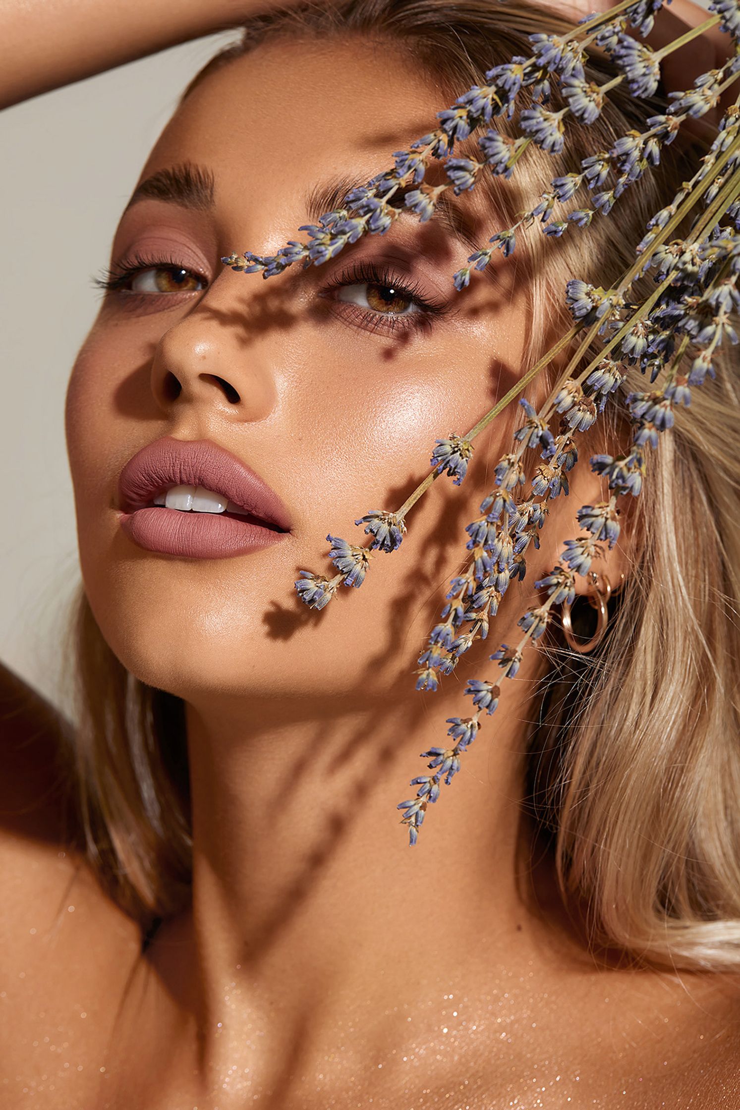 a woman with lavender flowers on her face