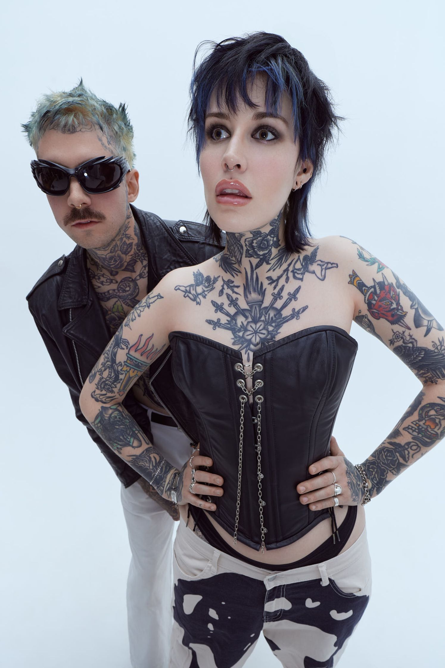 a man and a woman with tattoos