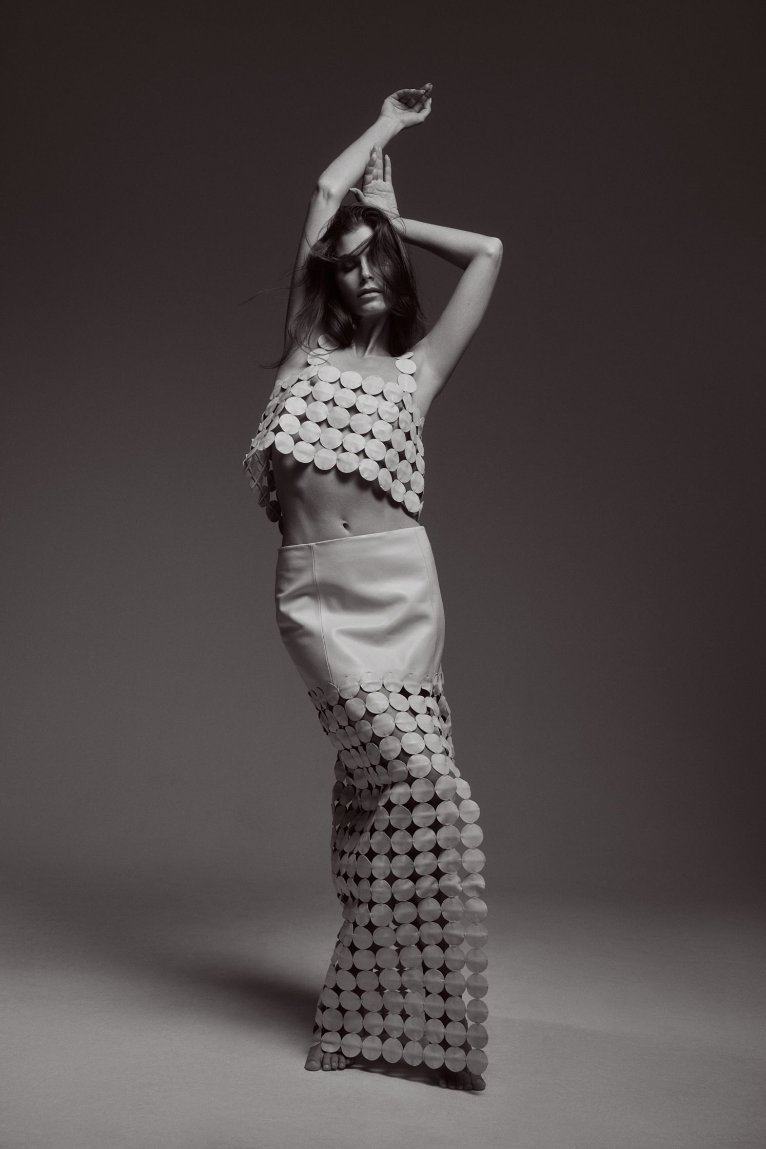 a black and white photo of a woman in a dress