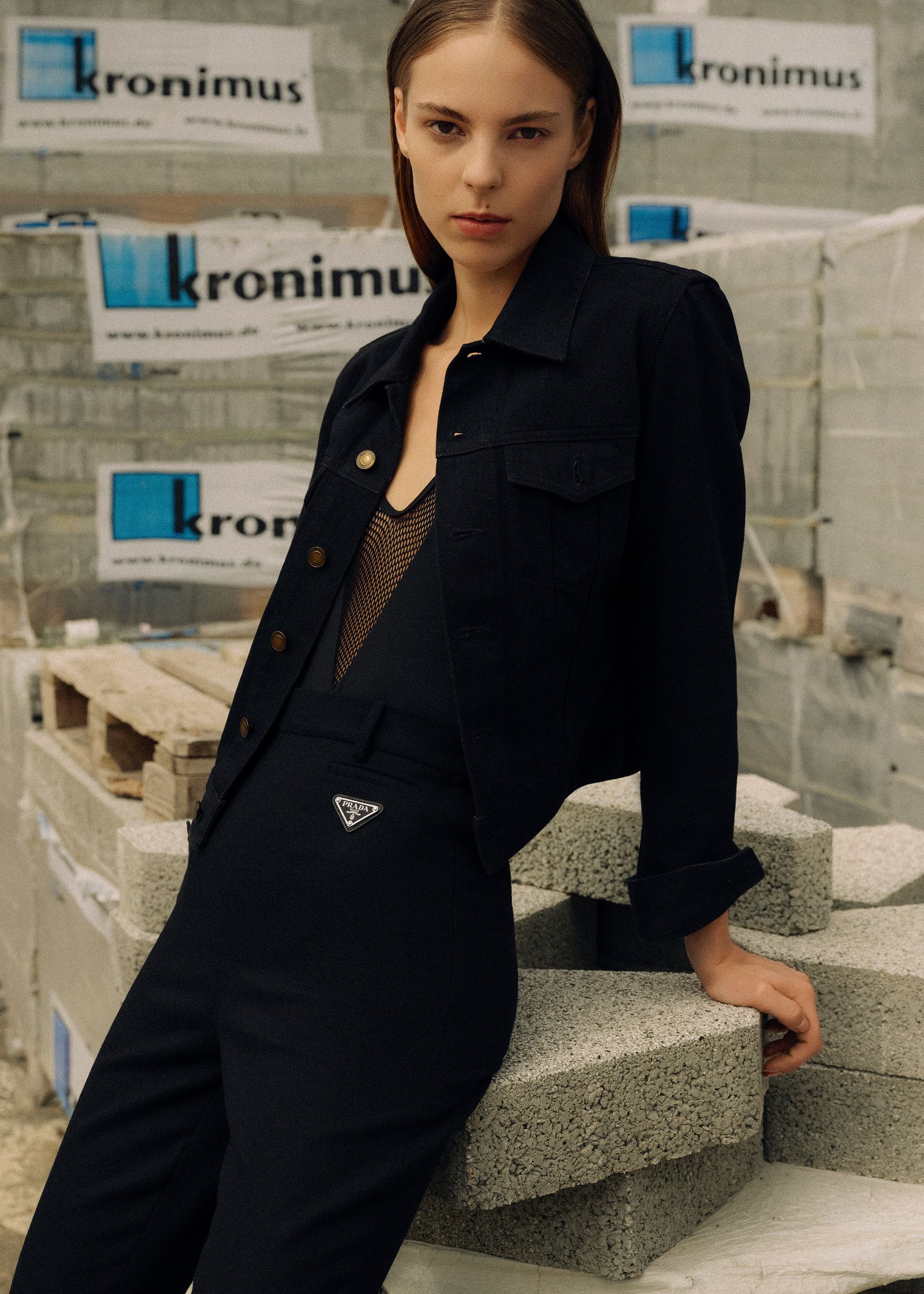 a model is posing in a black jacket and pants