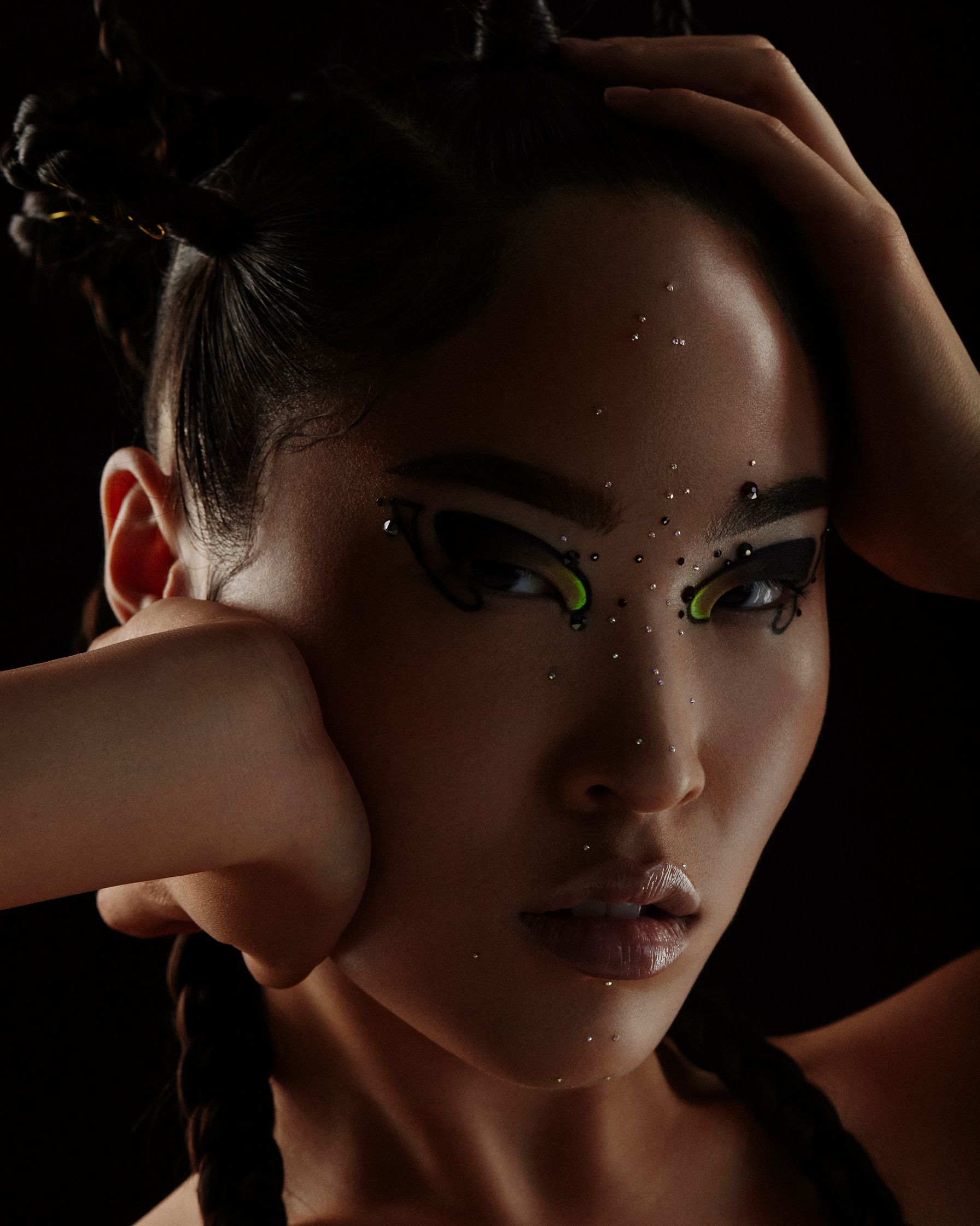 a woman with a black background and a cat eye makeup