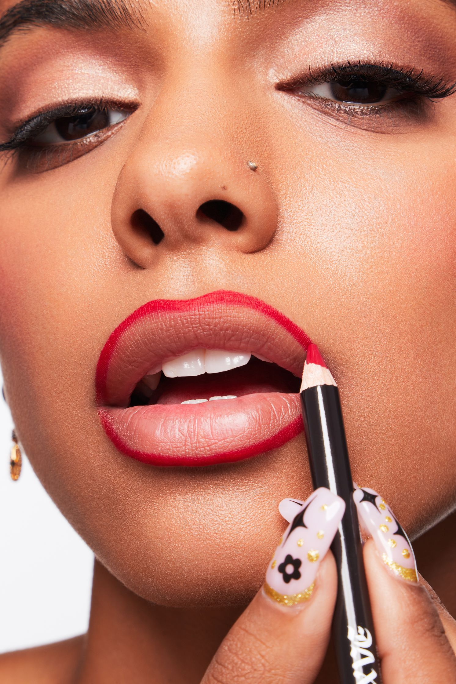 a woman is putting lipstick on her lips