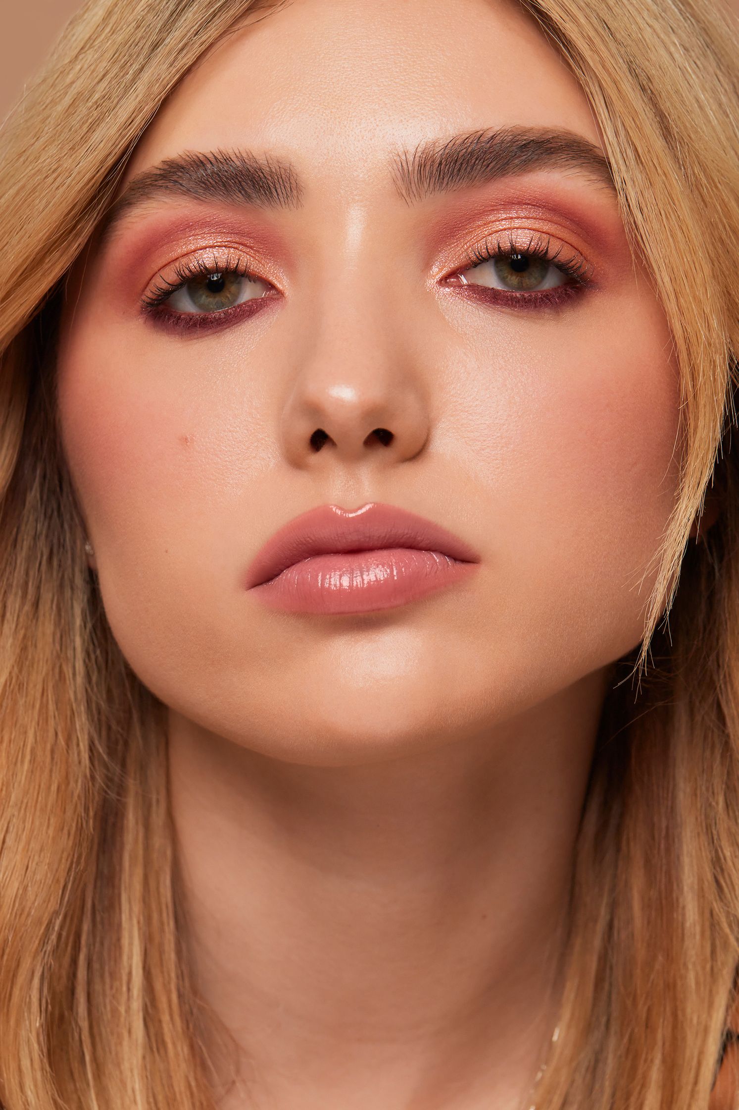 a woman with blond hair and pink eyeshadow