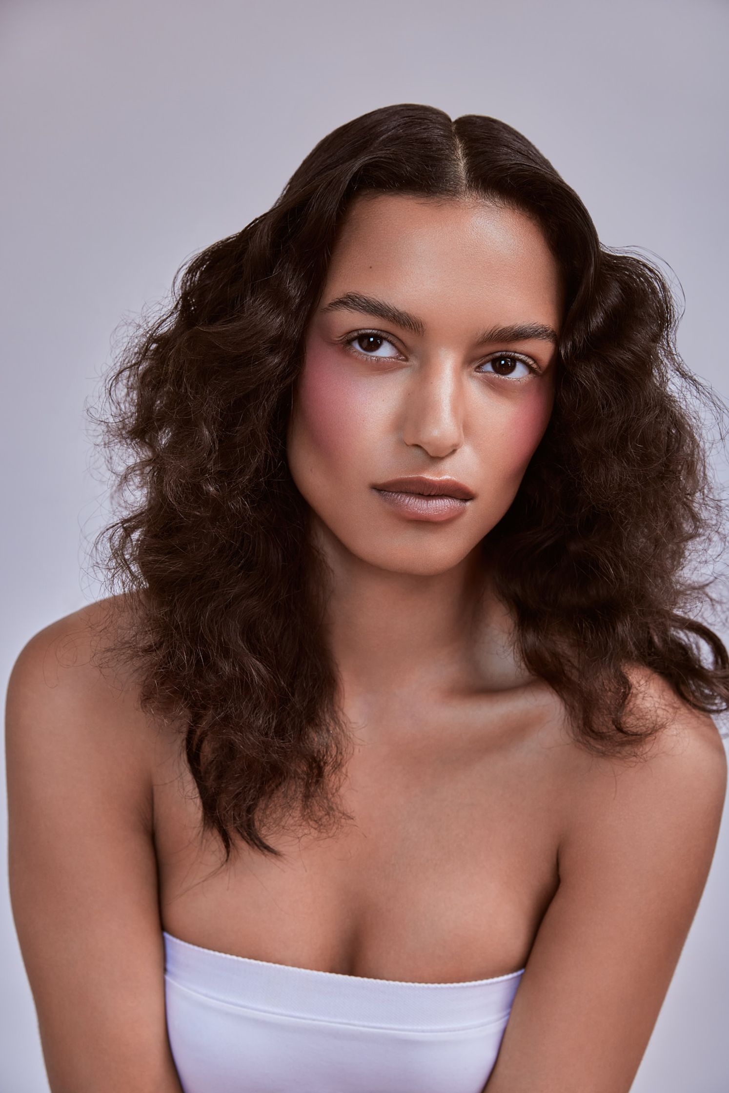 a woman with curly hair posing for a photo