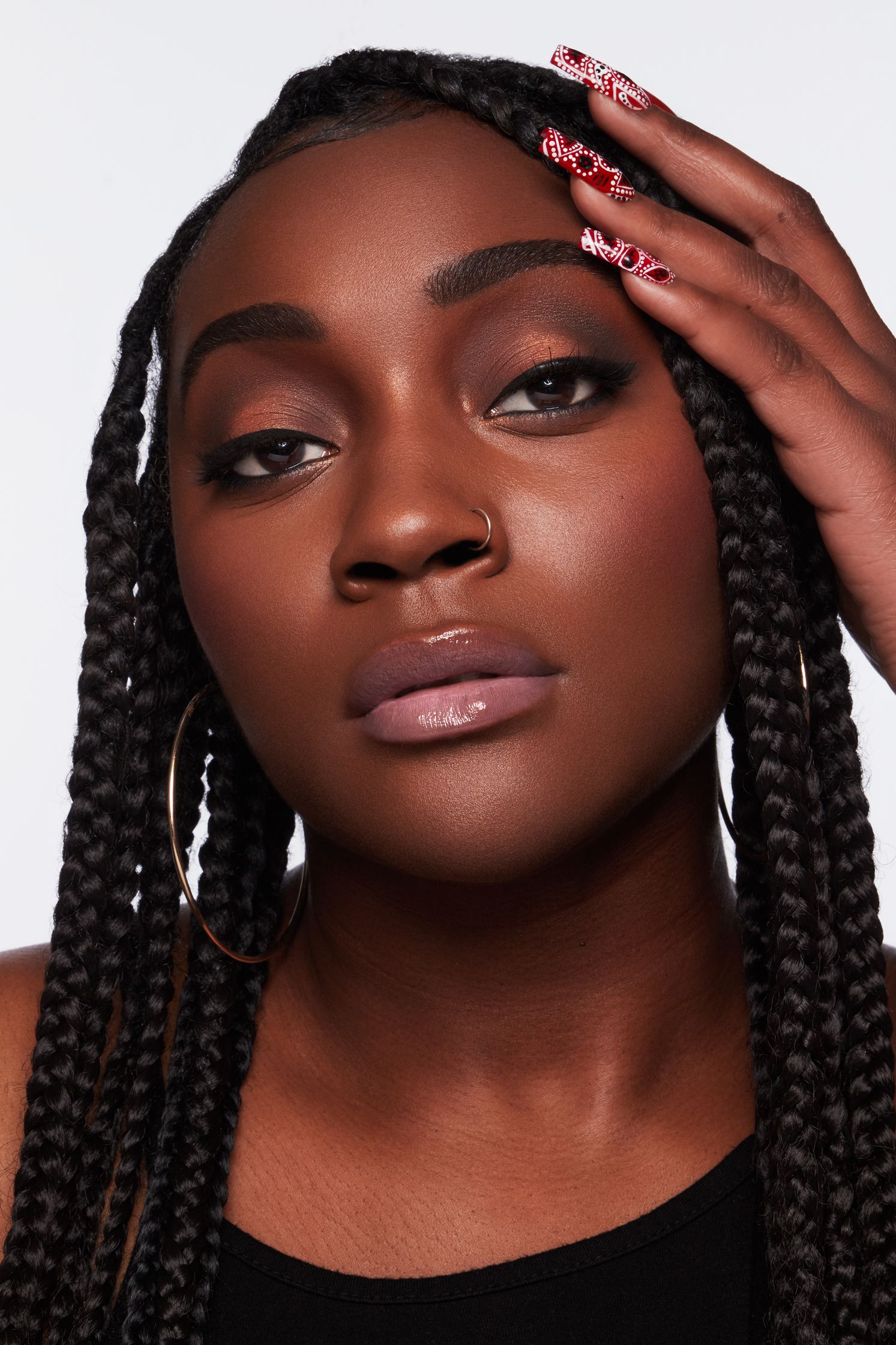 a black woman with braided hair posing for a photo