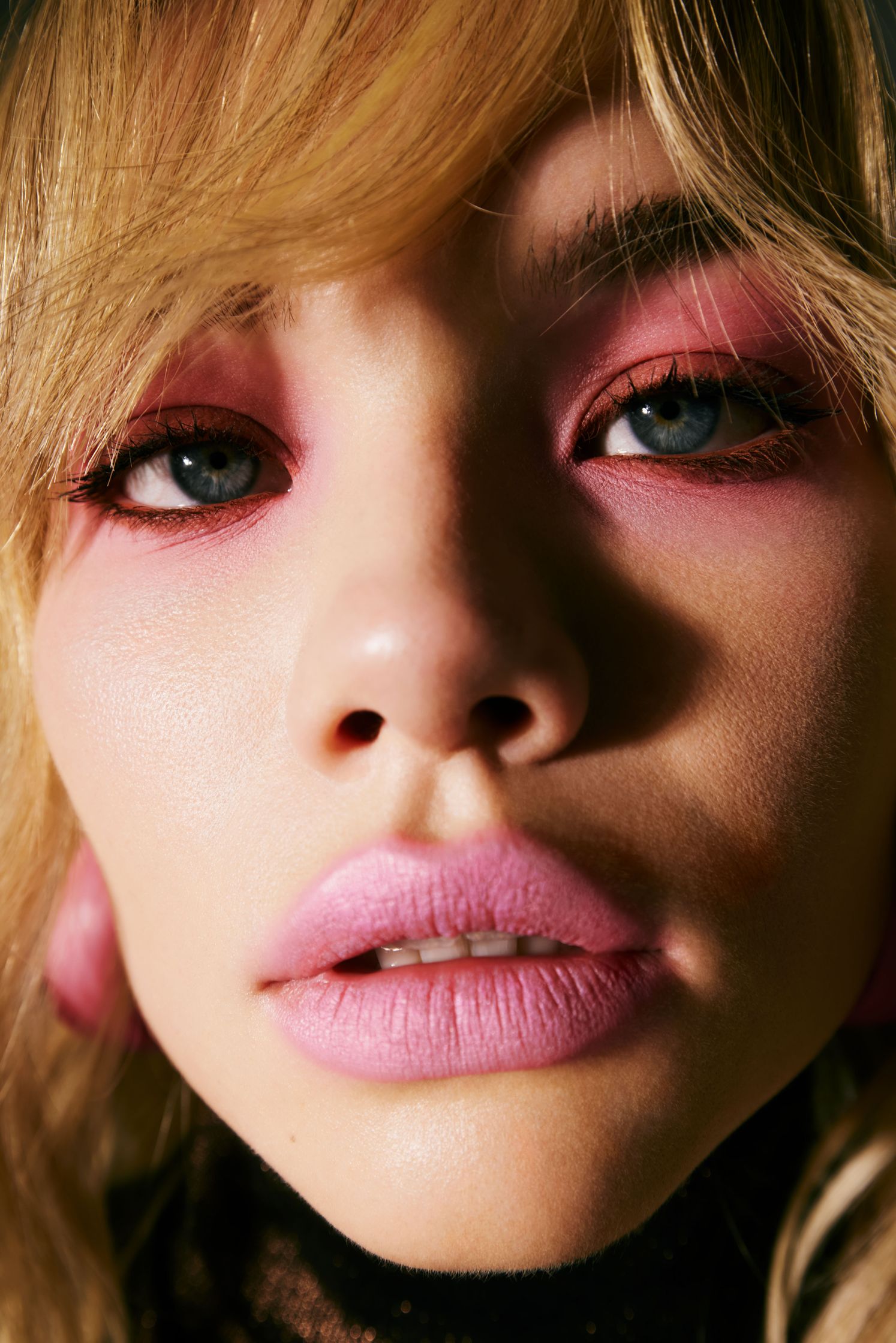a woman with pink eyeshadow and pink lips