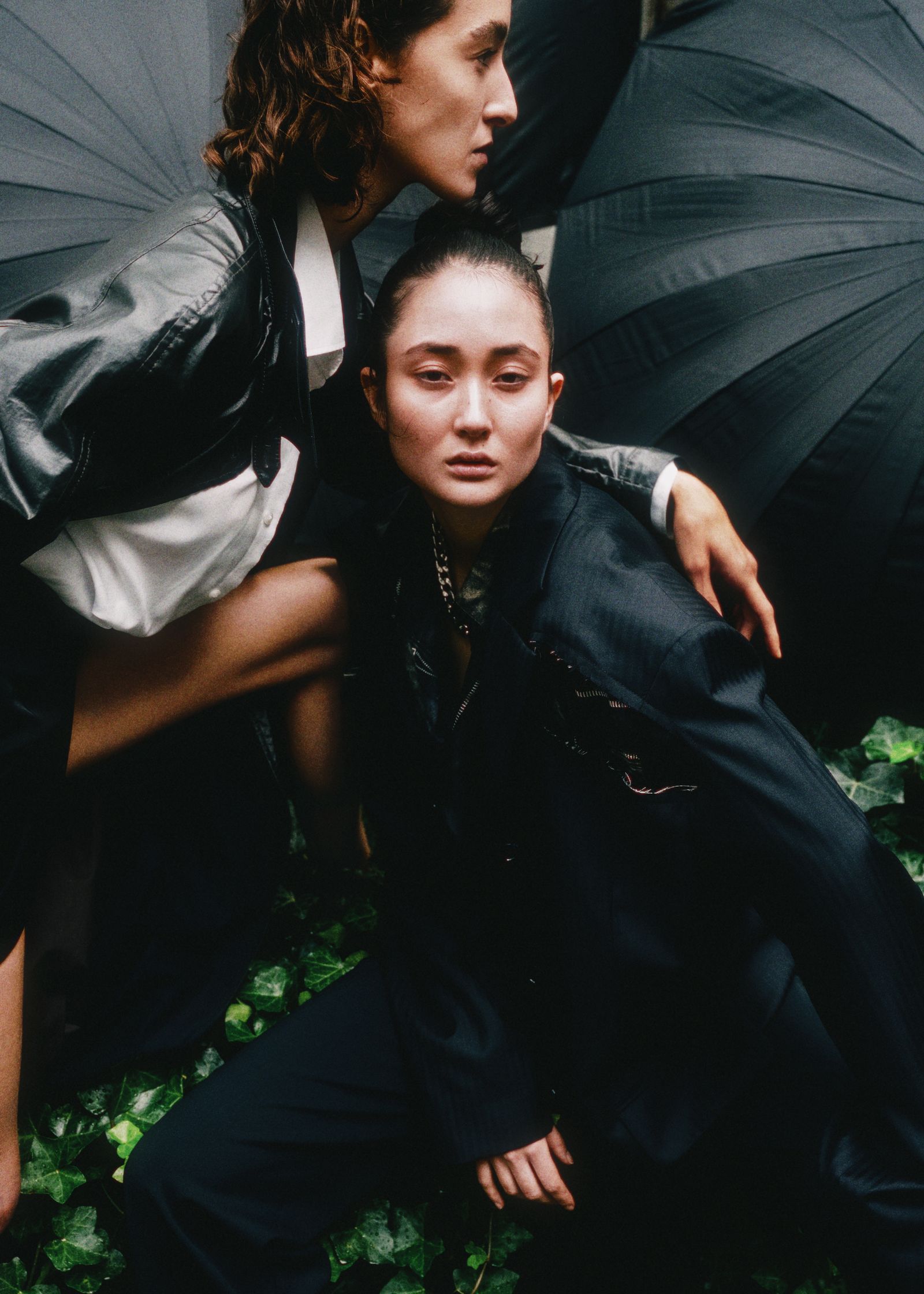 two women posing with umbrellas
