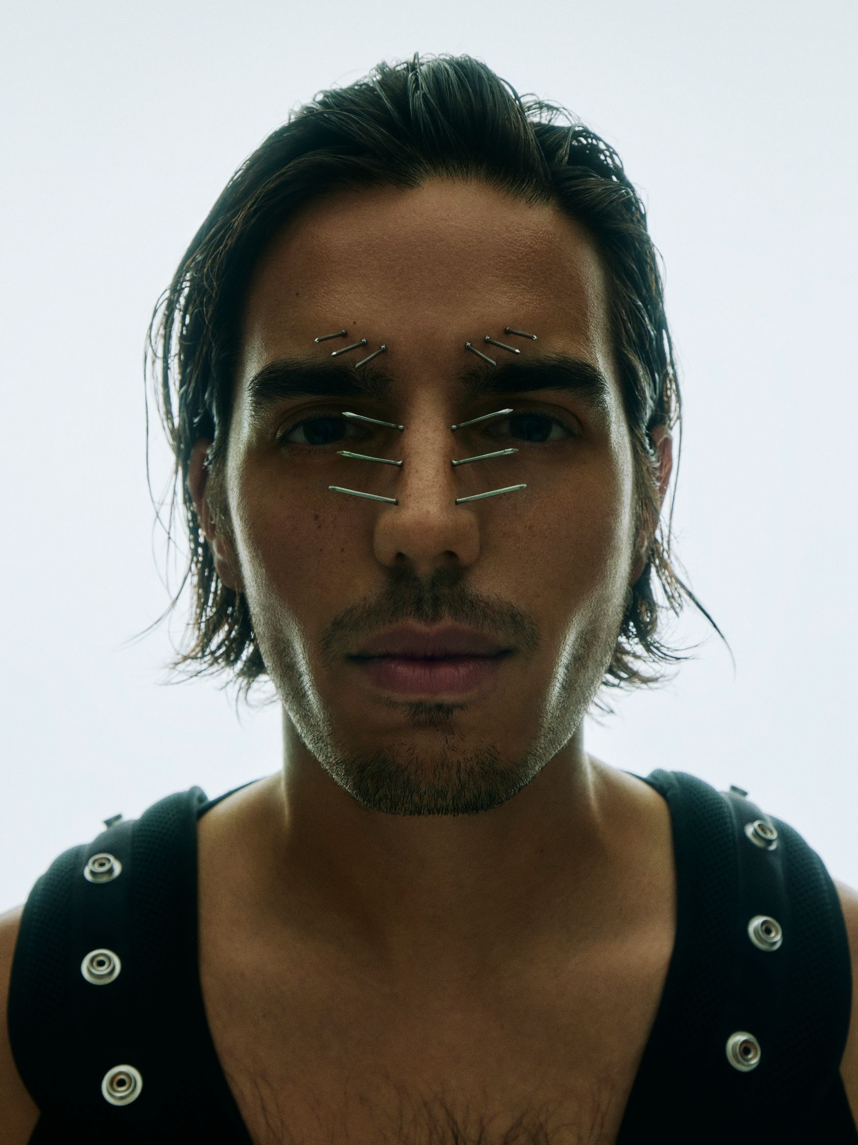a man with piercings on his face