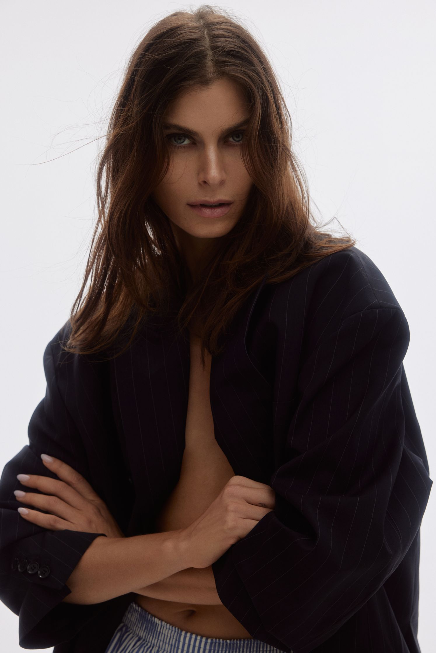 a woman in a black jacket and striped shorts