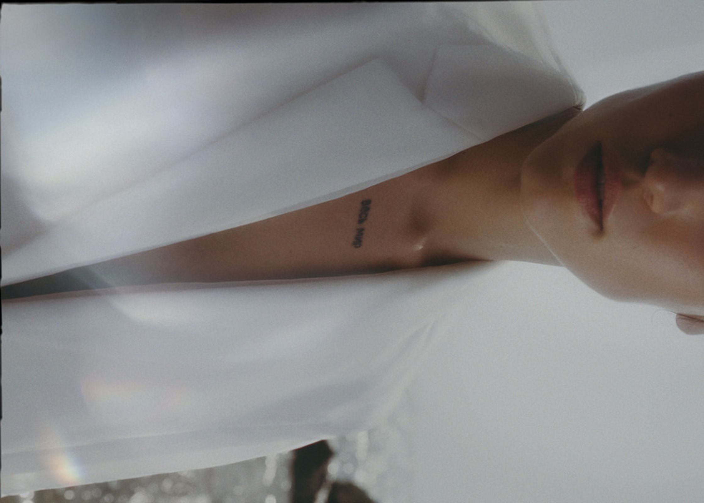 a woman wearing a white shirt and a necklace