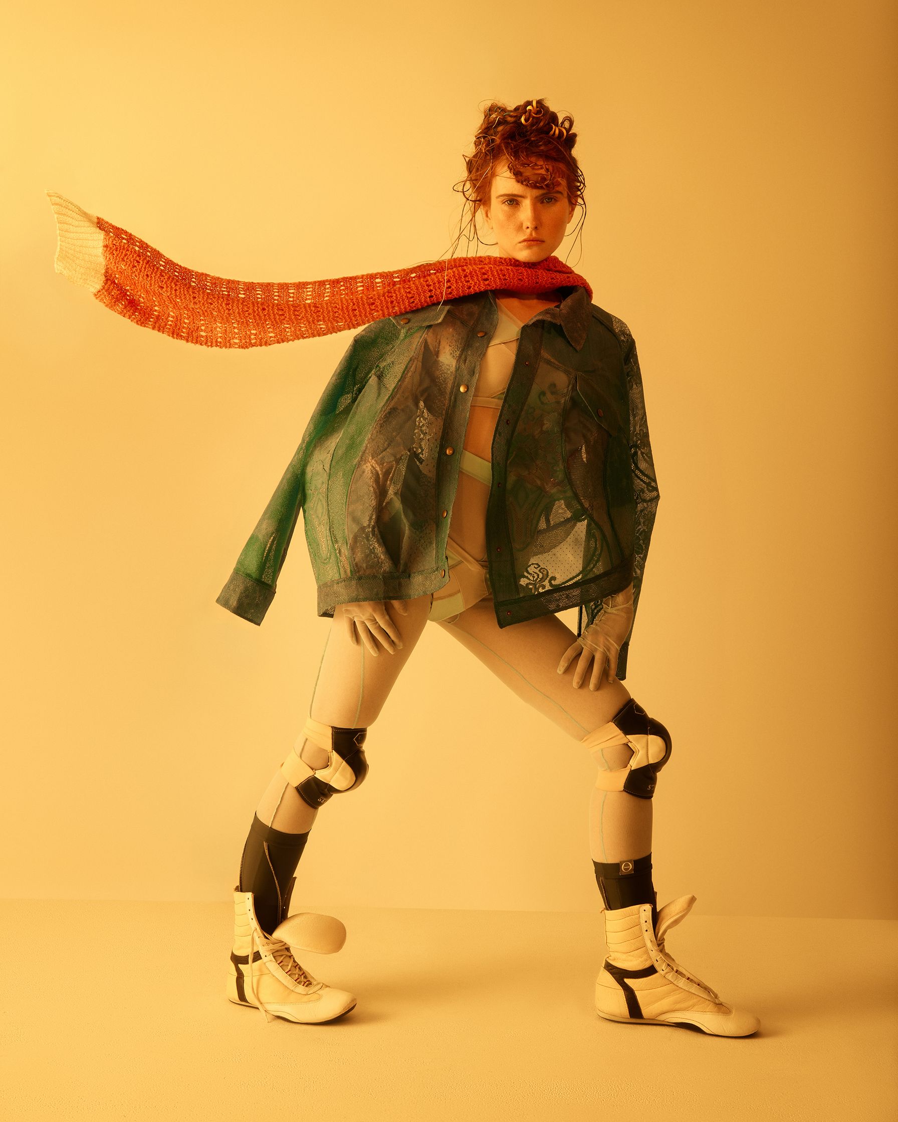 a woman wearing a scarf and a pair of boots