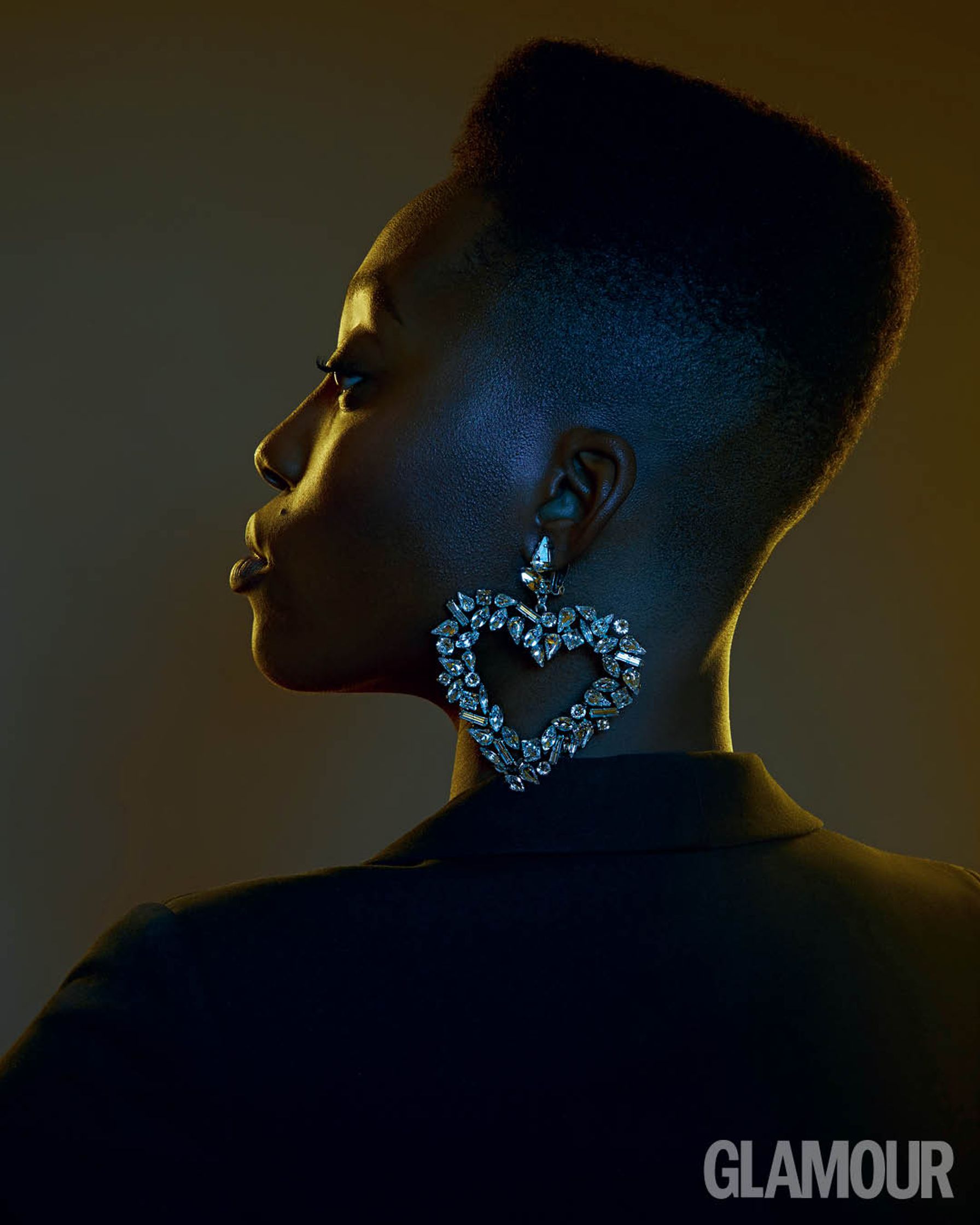a black woman with a heart shaped earring