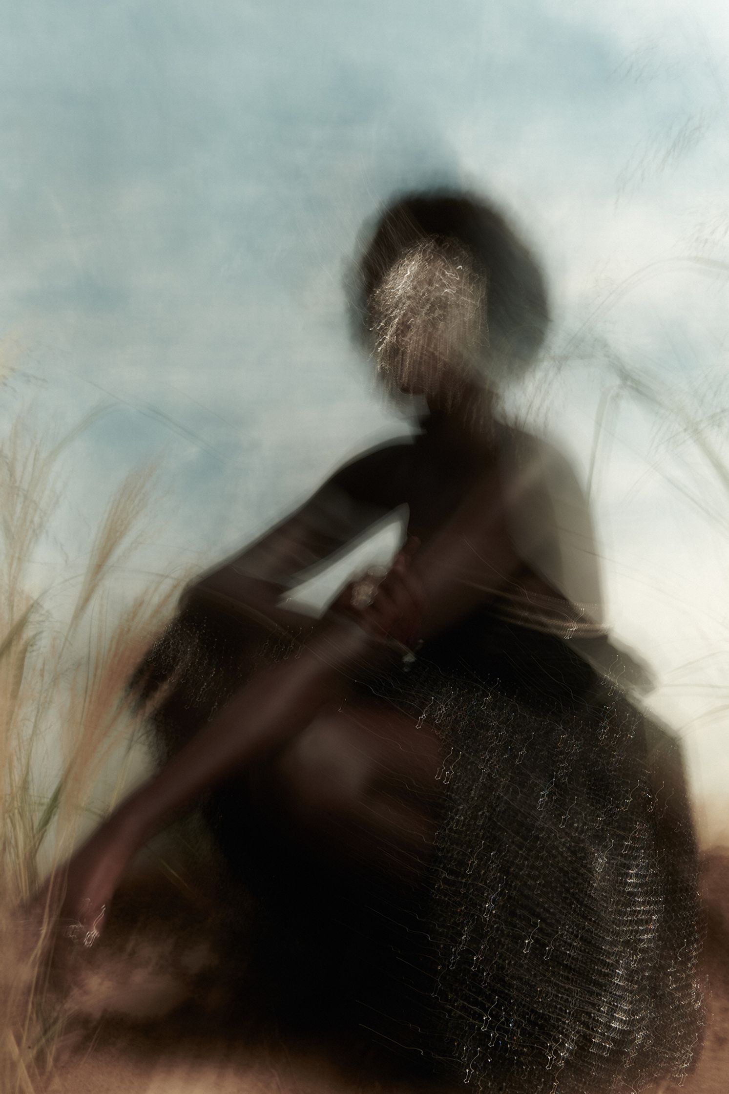an image of a woman sitting in a field