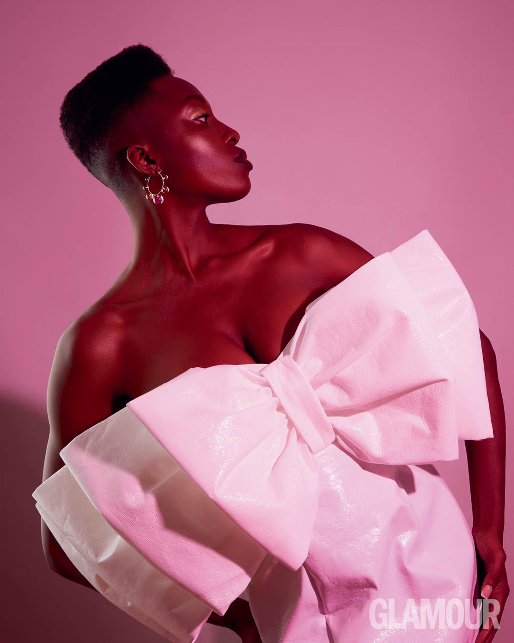 a black woman in a white dress posing for a photo