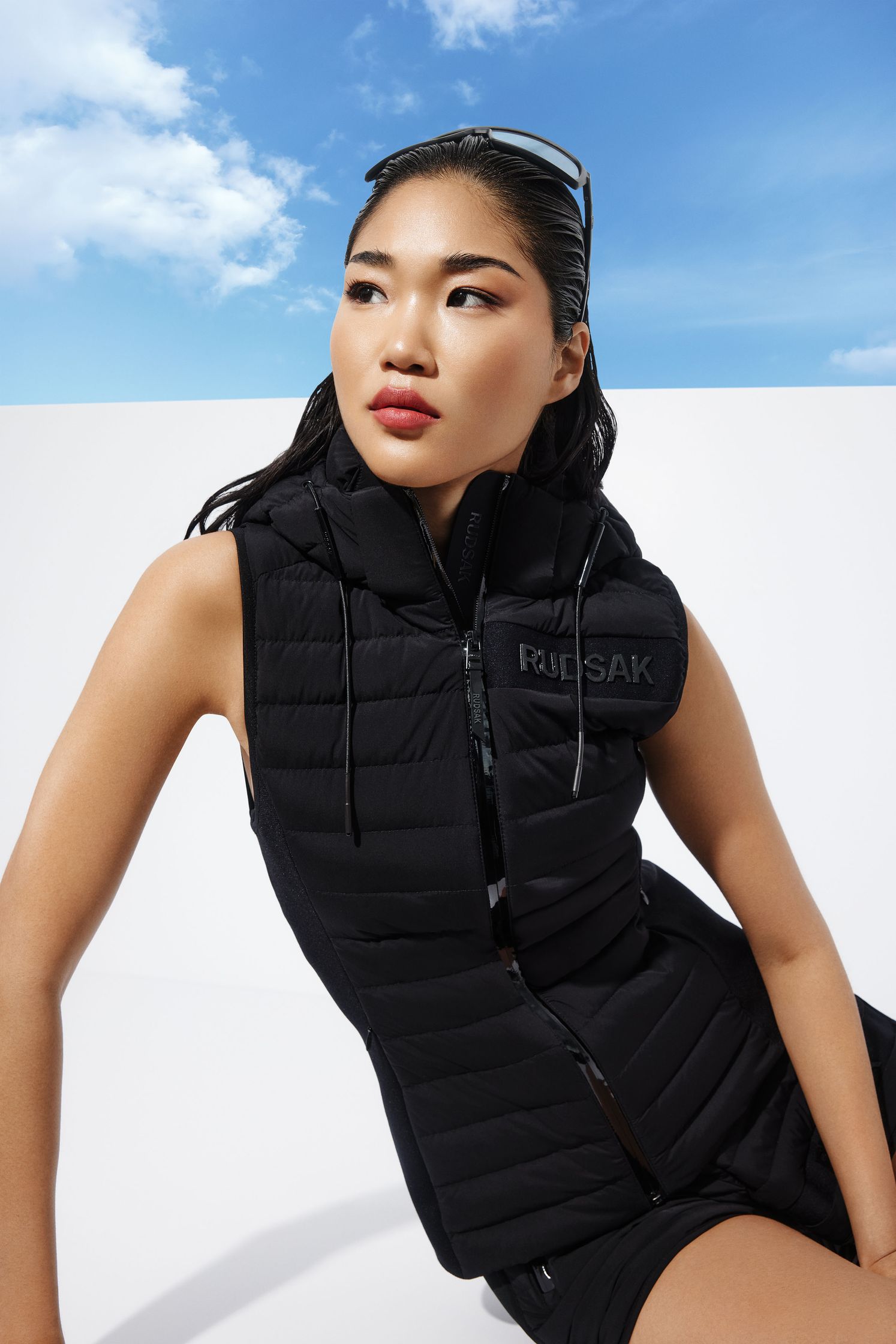 a woman posing in a black vest